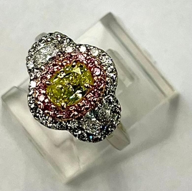 This is a very special ring containing a rare Fancy Intense Green Yellow Diamond that is also VS2 in clarity.  The color described as green yellow can vary in shade and hue from one diamond to  another and can often appear dingy and drab. How the