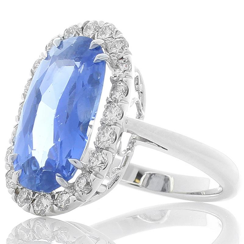 This stunning ring features undertones of vintage style while utilizing custom design elements. The natural 15.5 X 9.5 millimeter unheated bluish-violet sapphire captivates the eye. The stunning gemstone is GIA certified. The weight on this gemstone