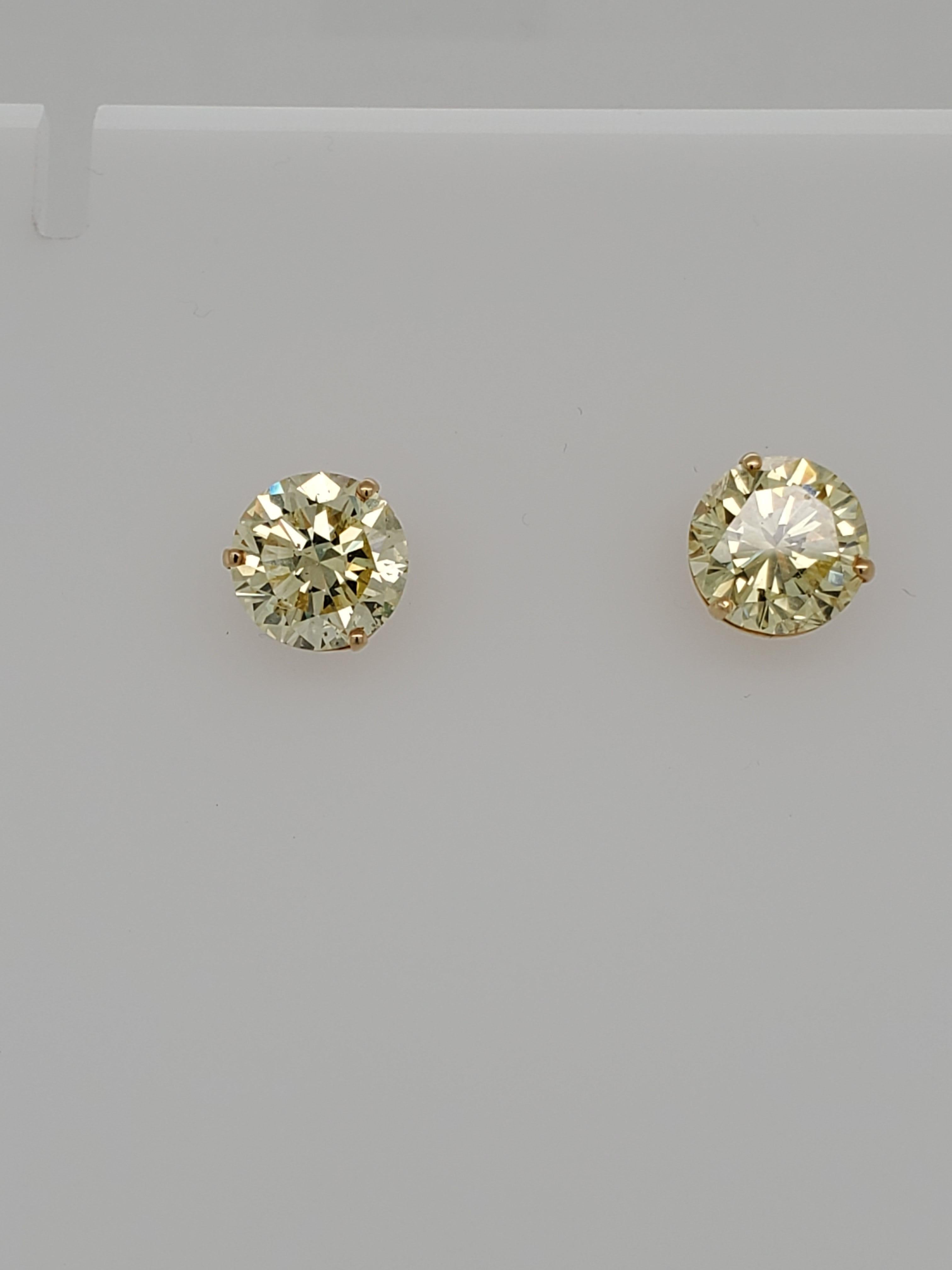GIA Certified Round Diamonds Cut to match. One weights 3.86 carats and is a Fancy Intense Yellow SI2 clarity and the second is 3.87 carats Fancy Yellow VVS2 clarity. Both set in a custom 18 karat yellow gold setting. 