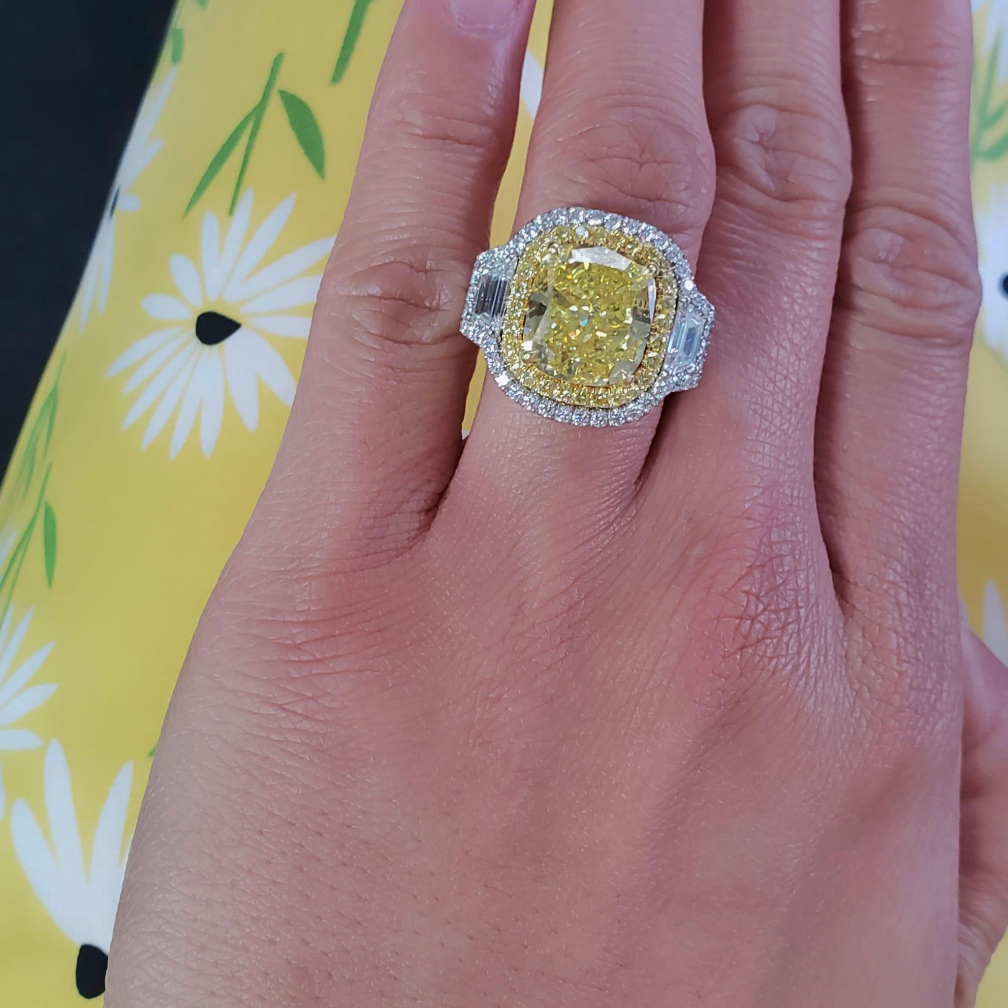 A Magnificent Platinum & 18k Ring,  GIA Certified Cushion Shaped Centerstone Diamond,  7.74 carat Natural Fancy Vivid Yellow (Canary). The clarity grade is SI1 (pleasant inclusion) with medium blue fluorescence. 

The stone measures