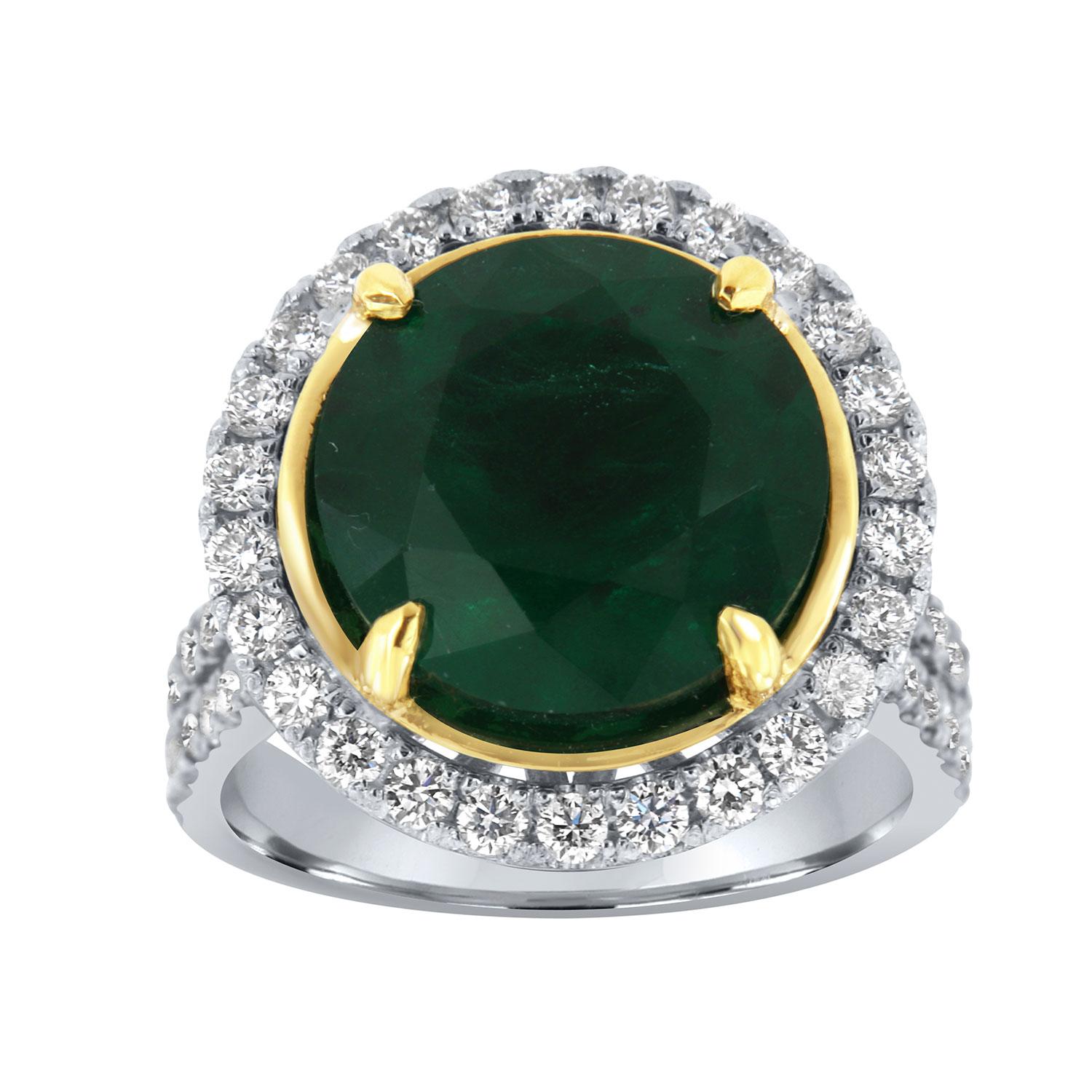 This Platinum & 18K Yellow gold ring features a RARE 7.77 Carat Round cut Natural Green emerald from Zambia. Excellent, bright, vibrant green color. The emerald is encircled by a halo of brilliant round diamonds on a 4.00 mm wide split shank band.
