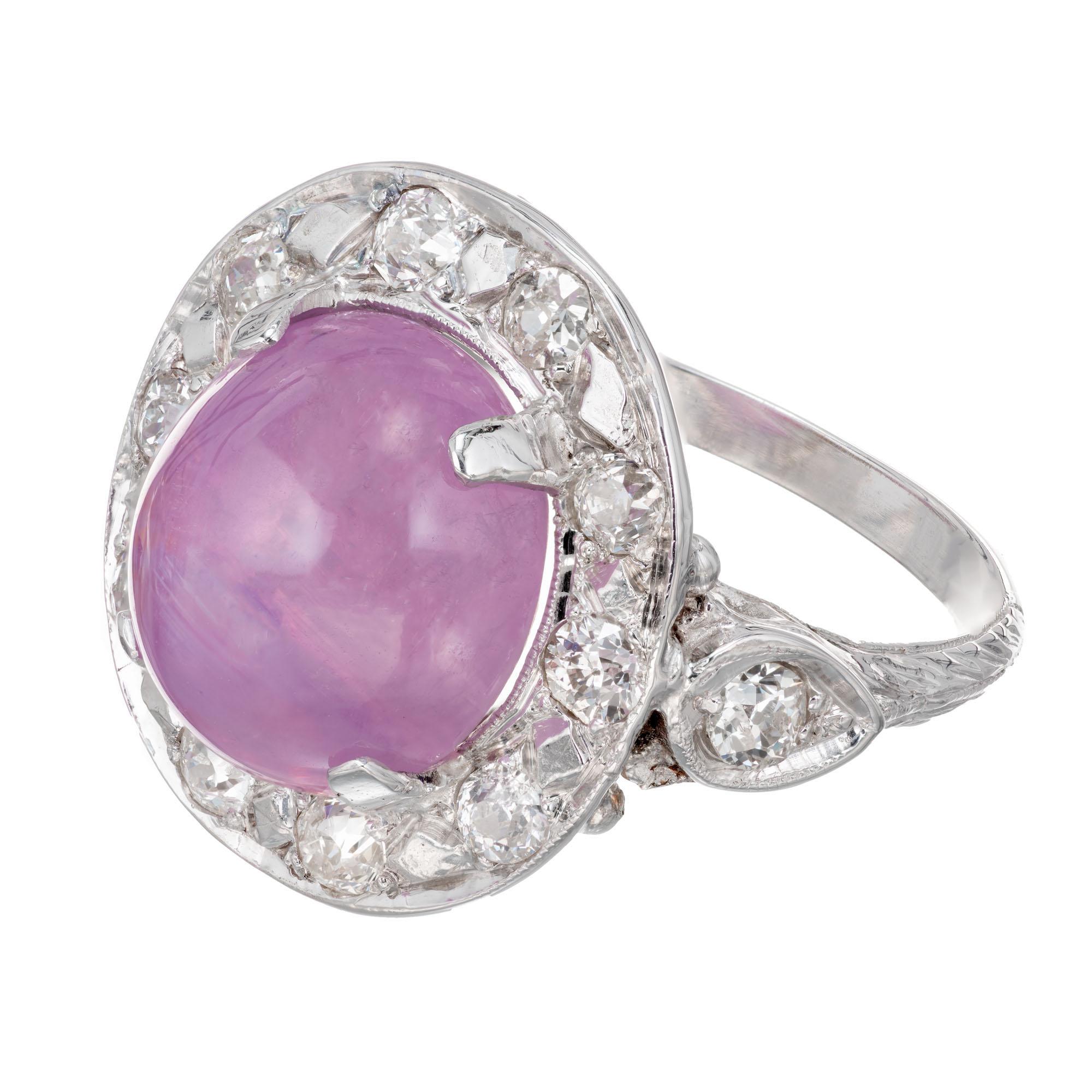 GIA certified natural purple pink cabochon star sapphire diamond ring. 7.77 carat oval center sapphire with a halo of 12 old European cut diamonds in a 14k white gold setting. Circa 1950's.

1 oval cabochon purplish pink star sapphire, approx.