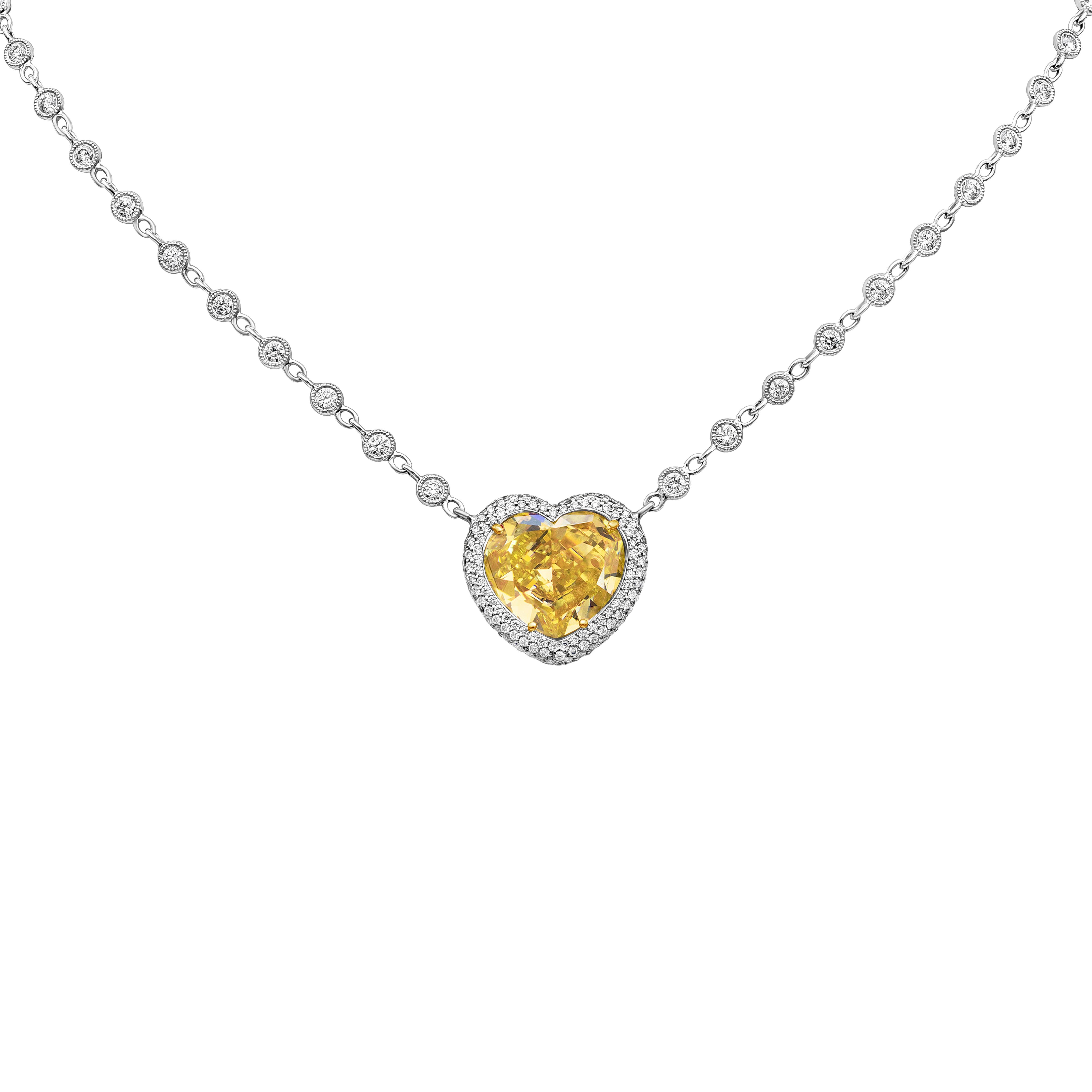 This elegant pendant features a GIA Certified 7.77 carats fancy yellow heart-shape diamond, SI2 in Clarity. The center stone accented by 432 round brilliant diamonds pave set all around and on the back, Round diamonds weighing 1.64 carats total.