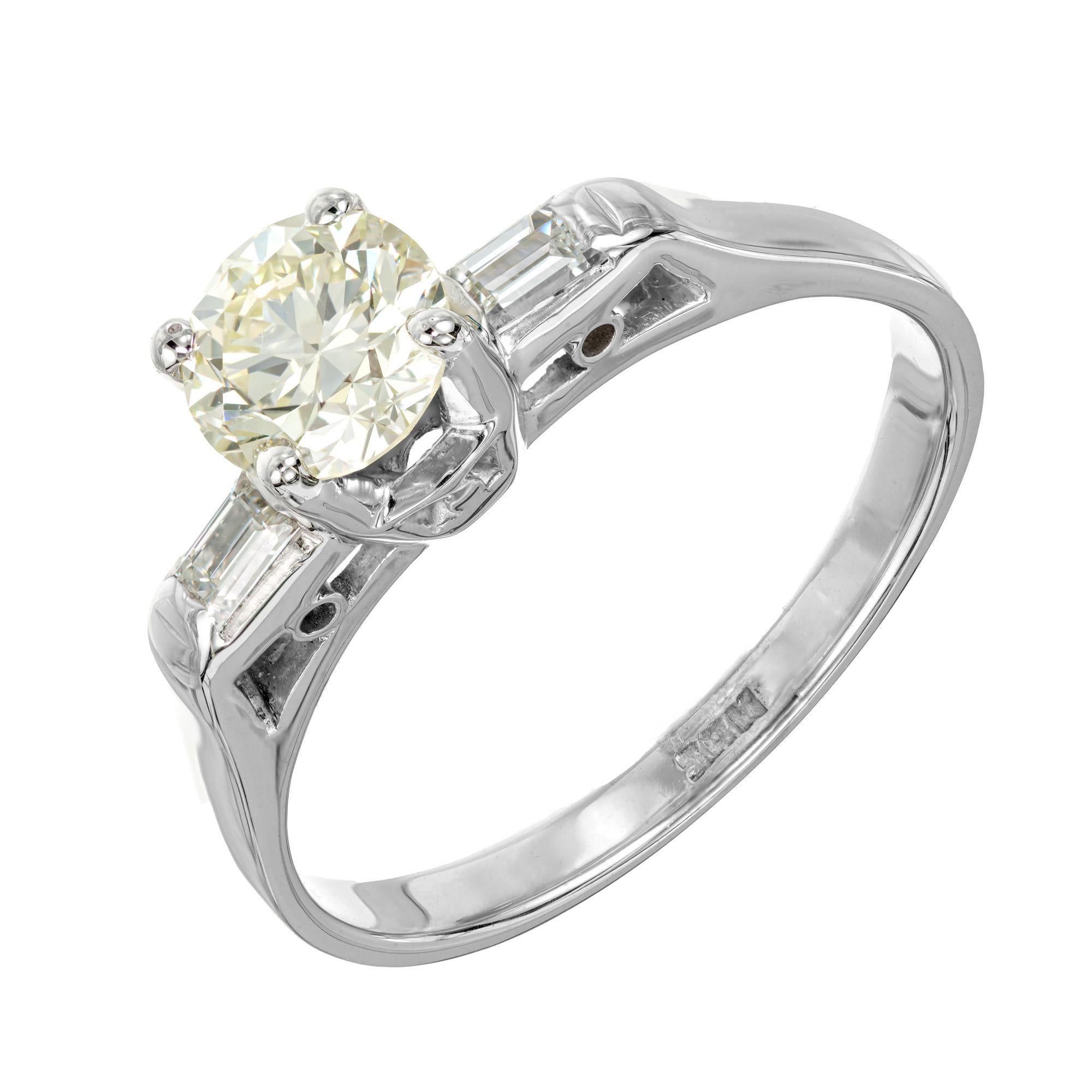 1920's Art Deco round diamond engagement ring. GIA certified .78 round brilliant cut light yellow center stone accented by two step cut baguette diamonds in a 18k white gold setting. 

1 round brilliant cut U-V VVS2 diamond, Approximate .78cts GIA 