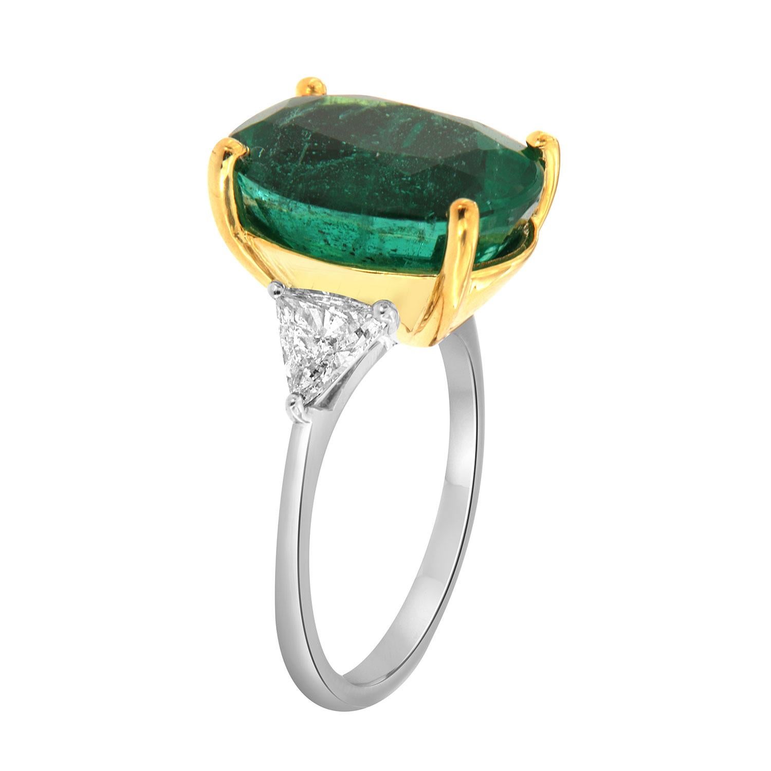 This classic Platinum and 18k Yellow Gold ring features a 7.89 Carat Oval-shaped Vibrant Bright green Natural Emerald flanked by two(2) Triangle-shaped diamonds in a total weight of 0.82 Carat on a 1.8 mm wide band. 
This Zambian Emerald exhibits a