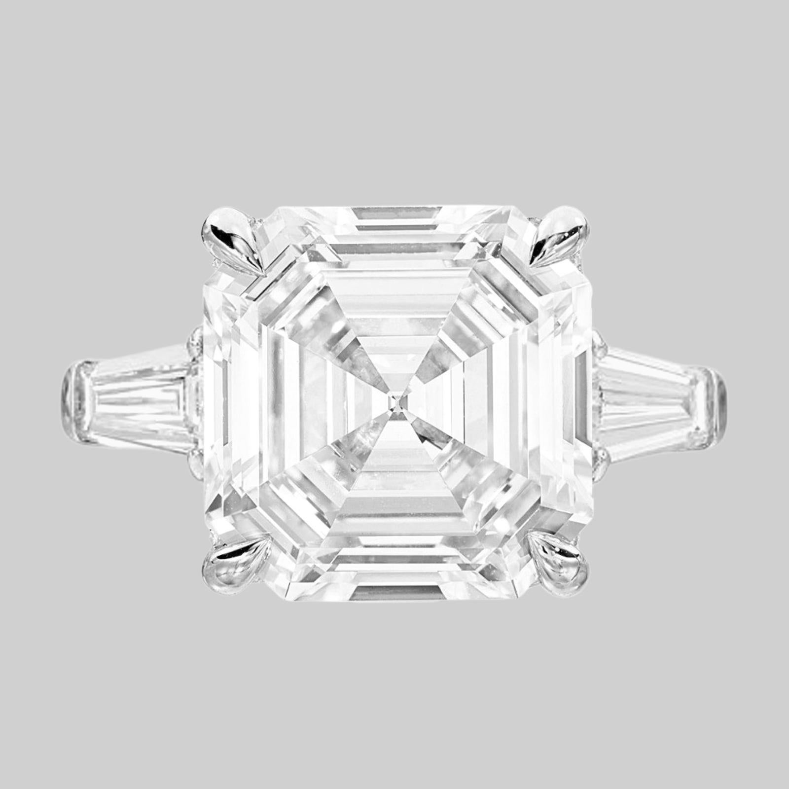Any Asscher-cut lover will fall for this nearly nine carat diamond classic engagement ring with its ideal platinum proportions, mirrored depths, and broad flashes of white light. The emerald-cut diamond was the result of increasing precision and