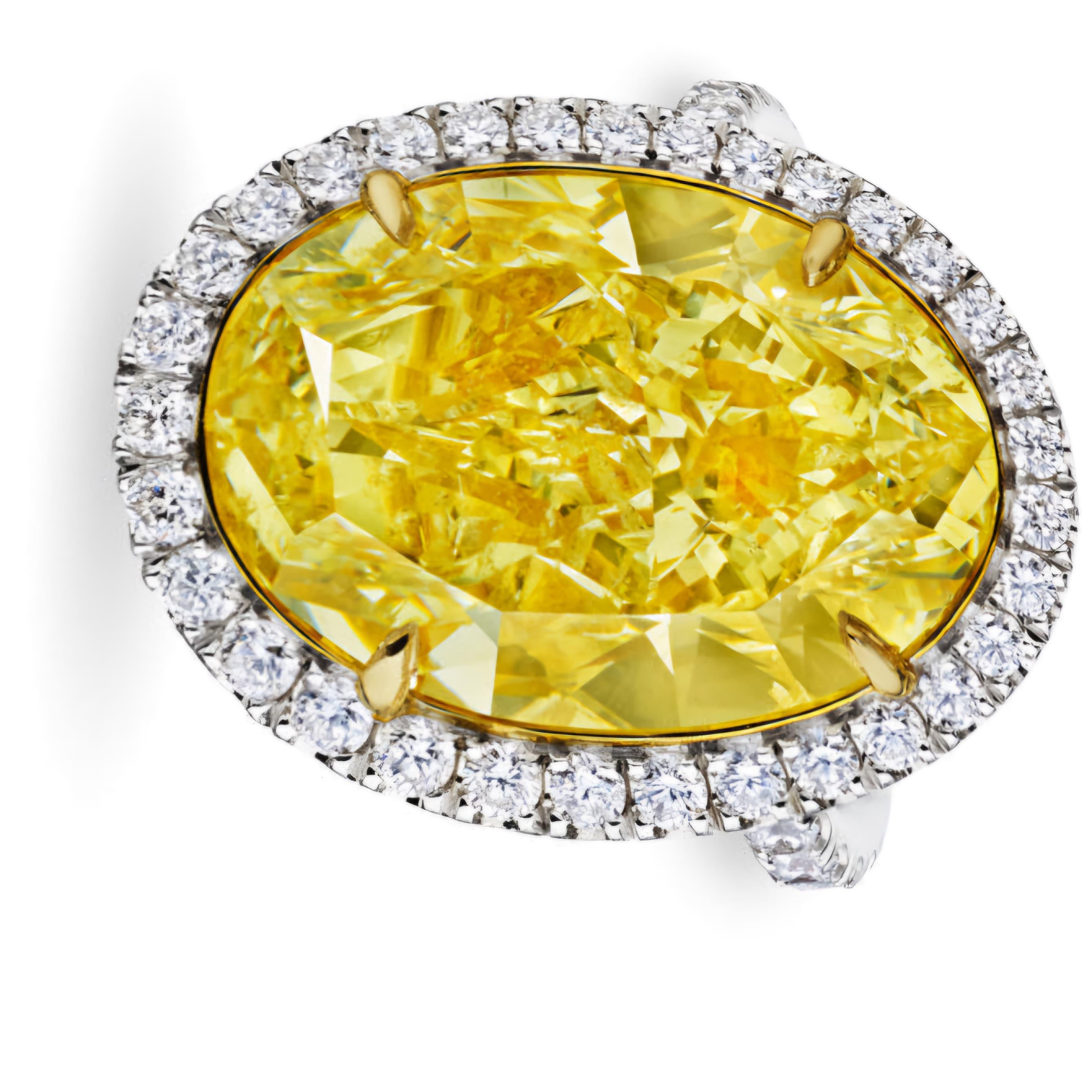 Discover the GIA Certified 8 Carat Fancy Yellow Oval Cut Diamond Halo Ring, crafted in 18K gold. A rare and radiant masterpiece of luxury and elegance.

Experience the pinnacle of opulence with the 8 Carat Fancy Yellow Oval Cut Diamond Halo Ring, a