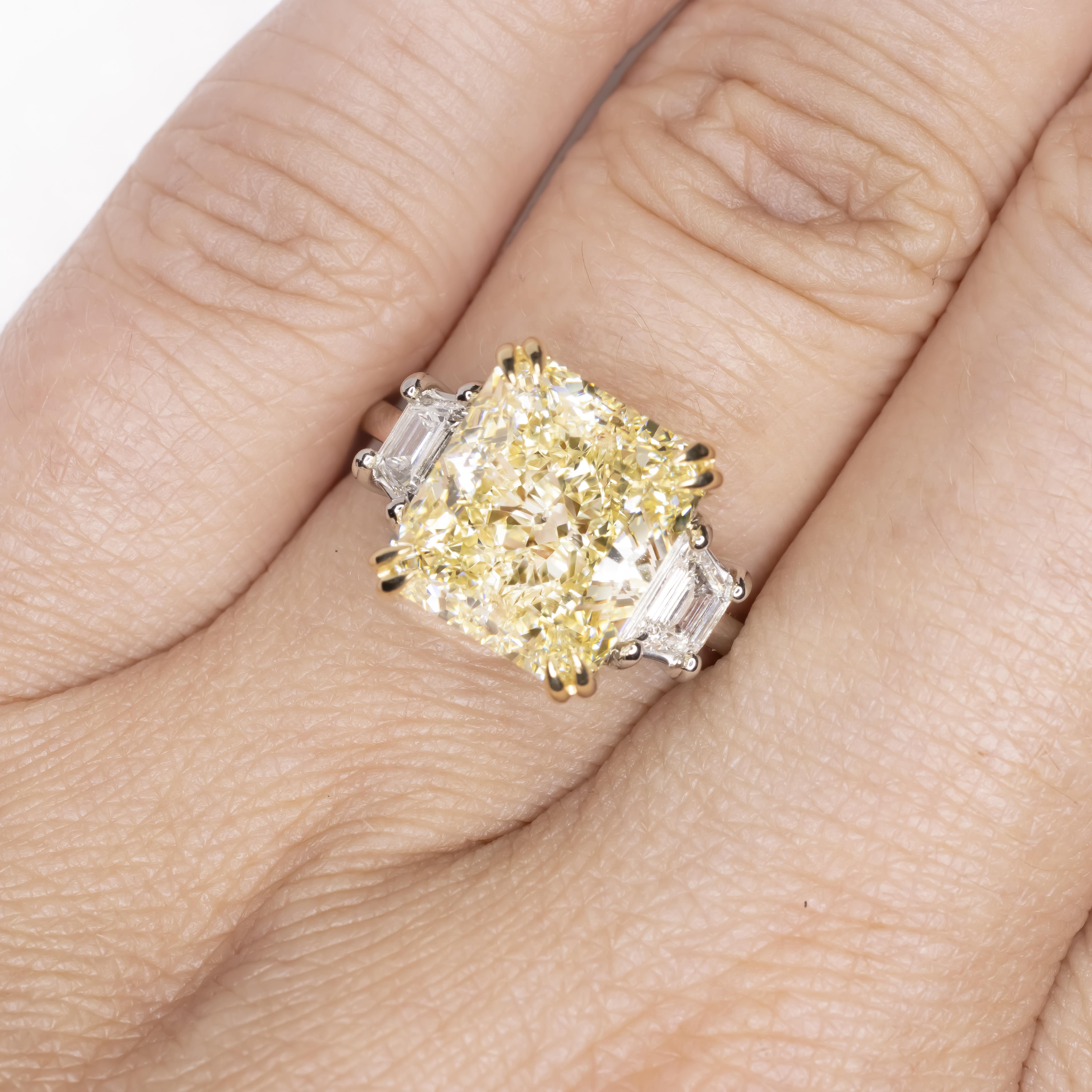 An exquisite 8 carat fancy yellow carat emerald cut diamond ring set in platinum and 18 carats yellow gold

The ring has been handmade with two side tapered baguettes also 100% eye clean and full of brilliance!