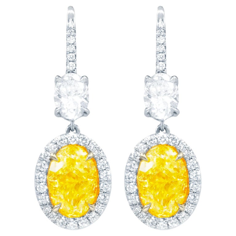GIA Certified 8 Carat Oval Shaped Yellow Diamond Earrings For Sale at