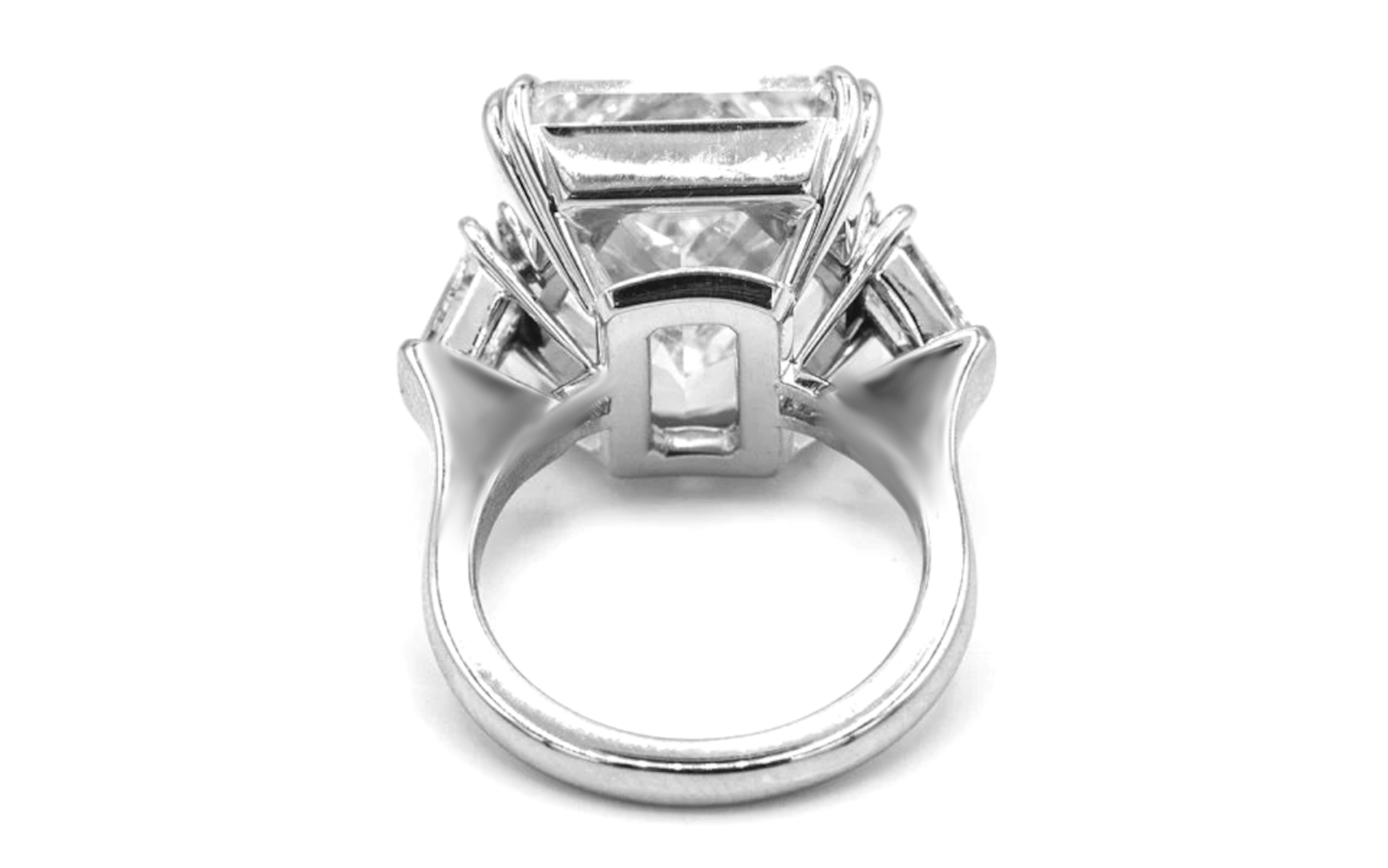 This spectacular statement ring showcases a breathtaking 8.05 carat cut-cornered rectangular modified brilliant diamond—also known as a radiant cut—certified by GIA as E color and VS2 clarity. The diamond displays remarkable brilliance and a