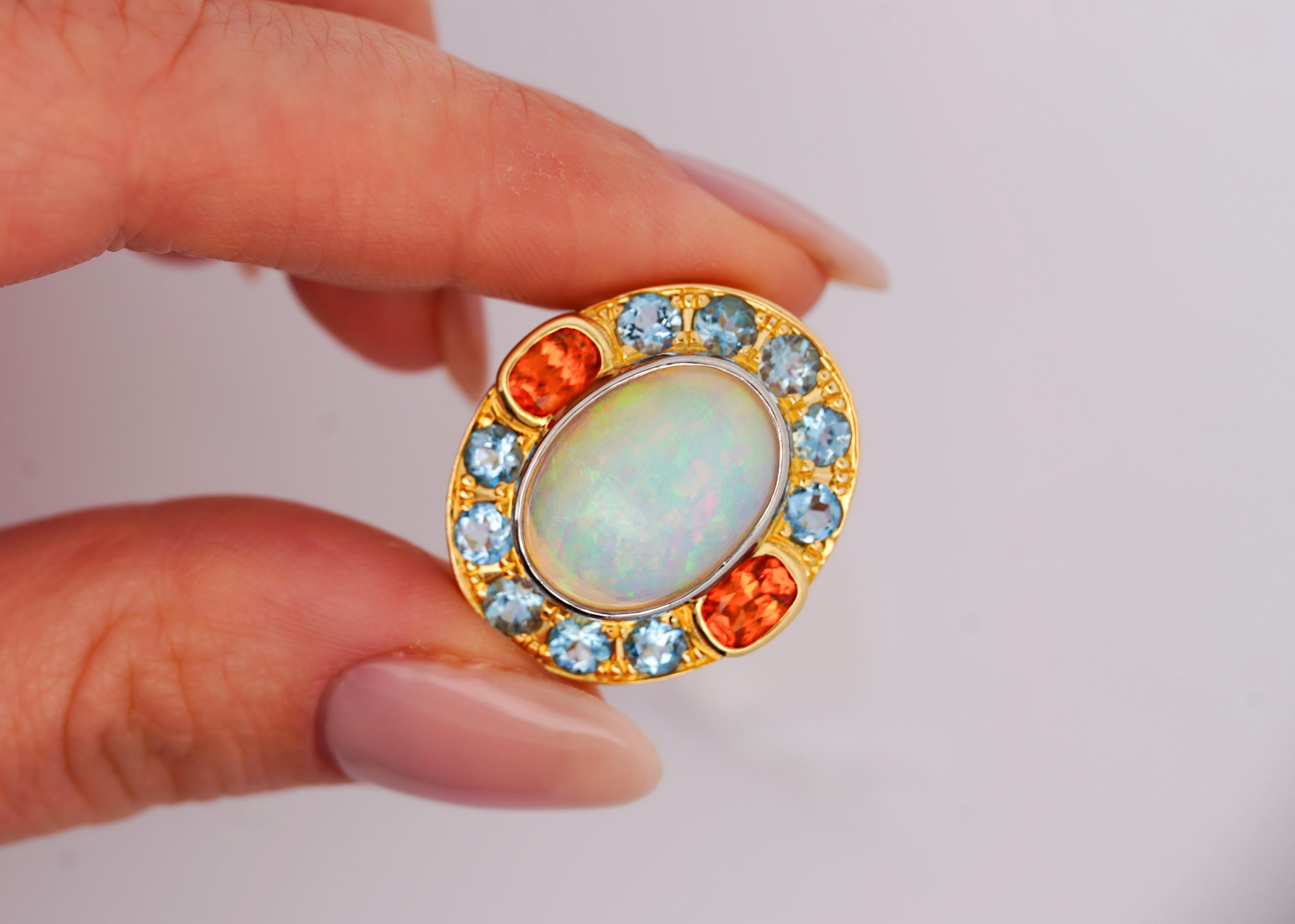 Natural 8 Carat White Opal with Orange Garnet and Aquamarine Ring.

This cocktail ring features an array of colored stones. The center features a bezel set 8 carat cabochon-cut white translucent opal with GIA certification. The opal is paired with a