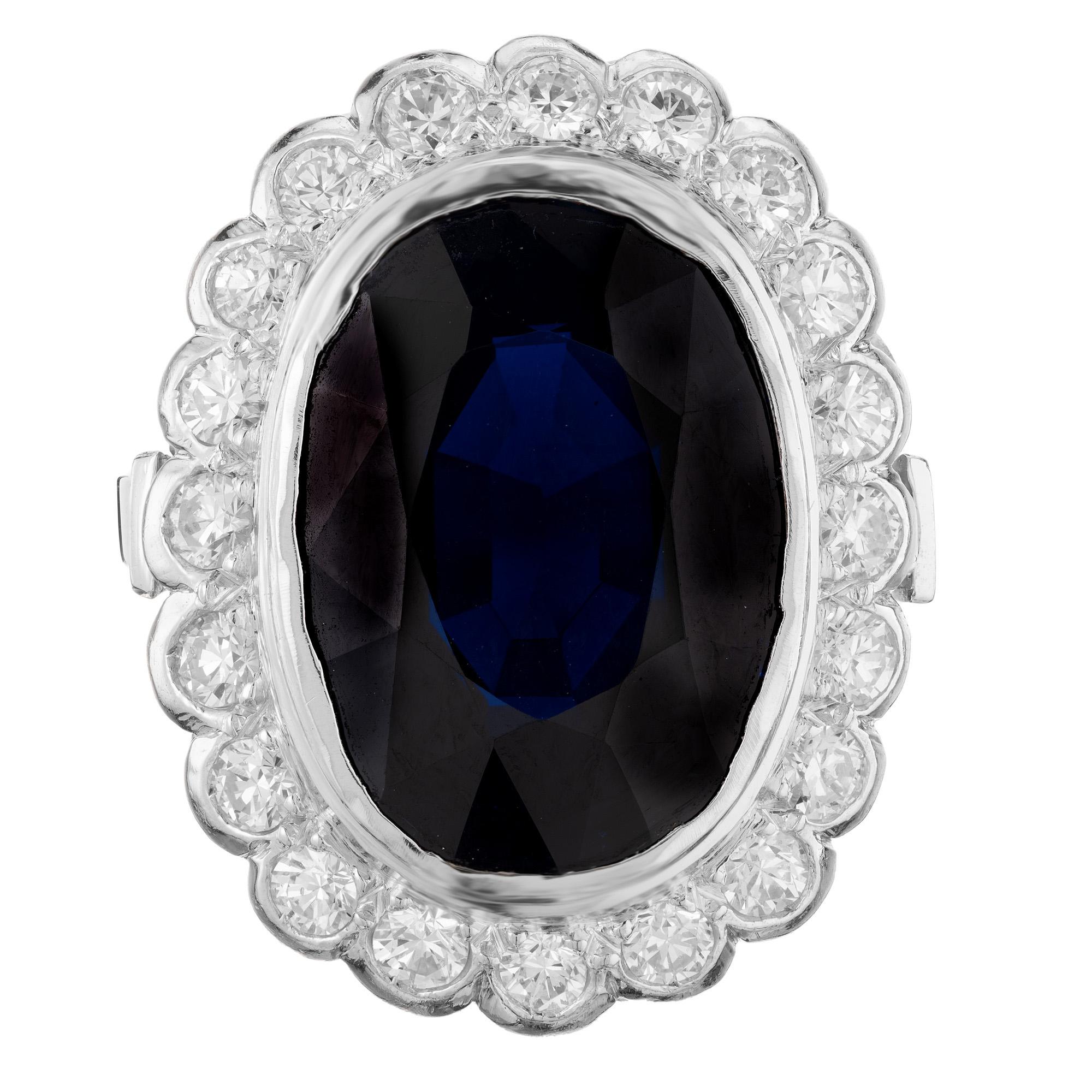 Vintage 1950's sensational sapphire and diamond engagement ring. Impressive 8.01ct oval dark blue sapphire mounted in a platinum scalloped rim setting with a halo of 20 round bezel set diamonds. The GIA has certified the sapphire as natural no heat.