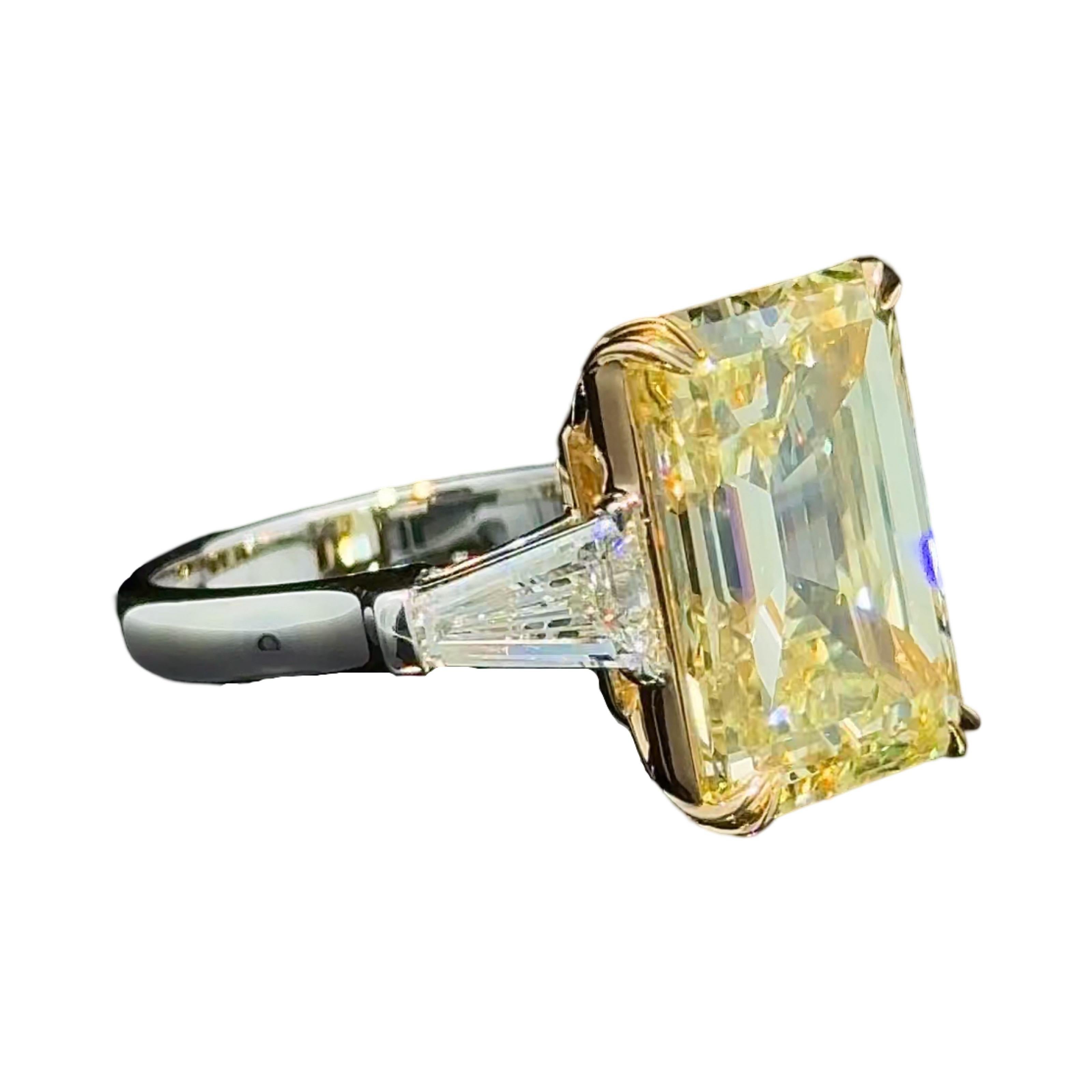 A statement Three Stone Ring showcasing an impeccably cut Natural Fancy Yellow Emerald Cut Diamond. 
Emerald Cuts are one of the rarest cuts amongst Fancy Color Diamonds, and they are even more unusual to see with length to with ratios of over 1.35