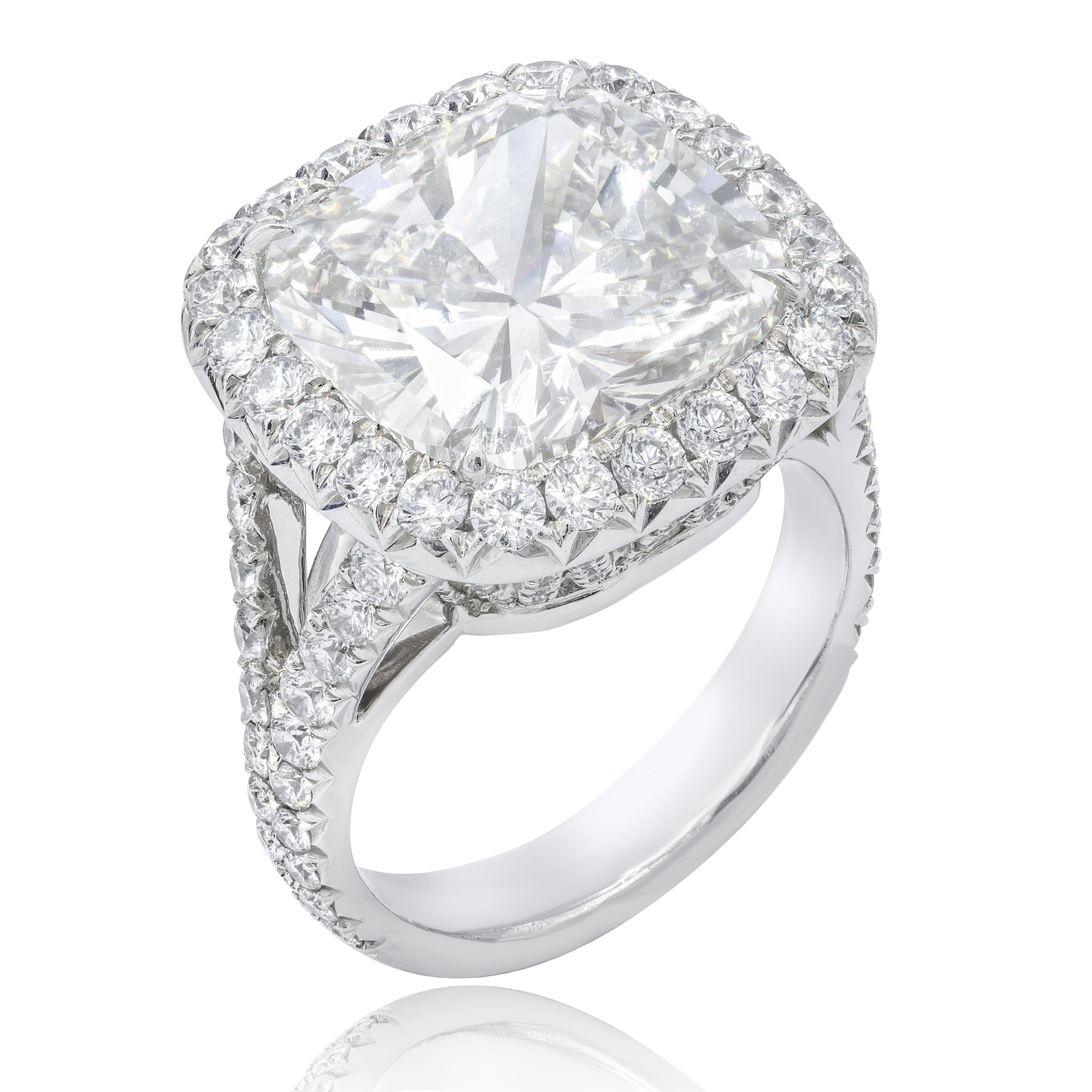 Platinum handmade diamond ring, features 8.03 Carats Cushion Cut diamond, J in Color VS2 in Clarity, certified by GIA, surrounded by 2.50 carats of round brilliant cut diamonds.
