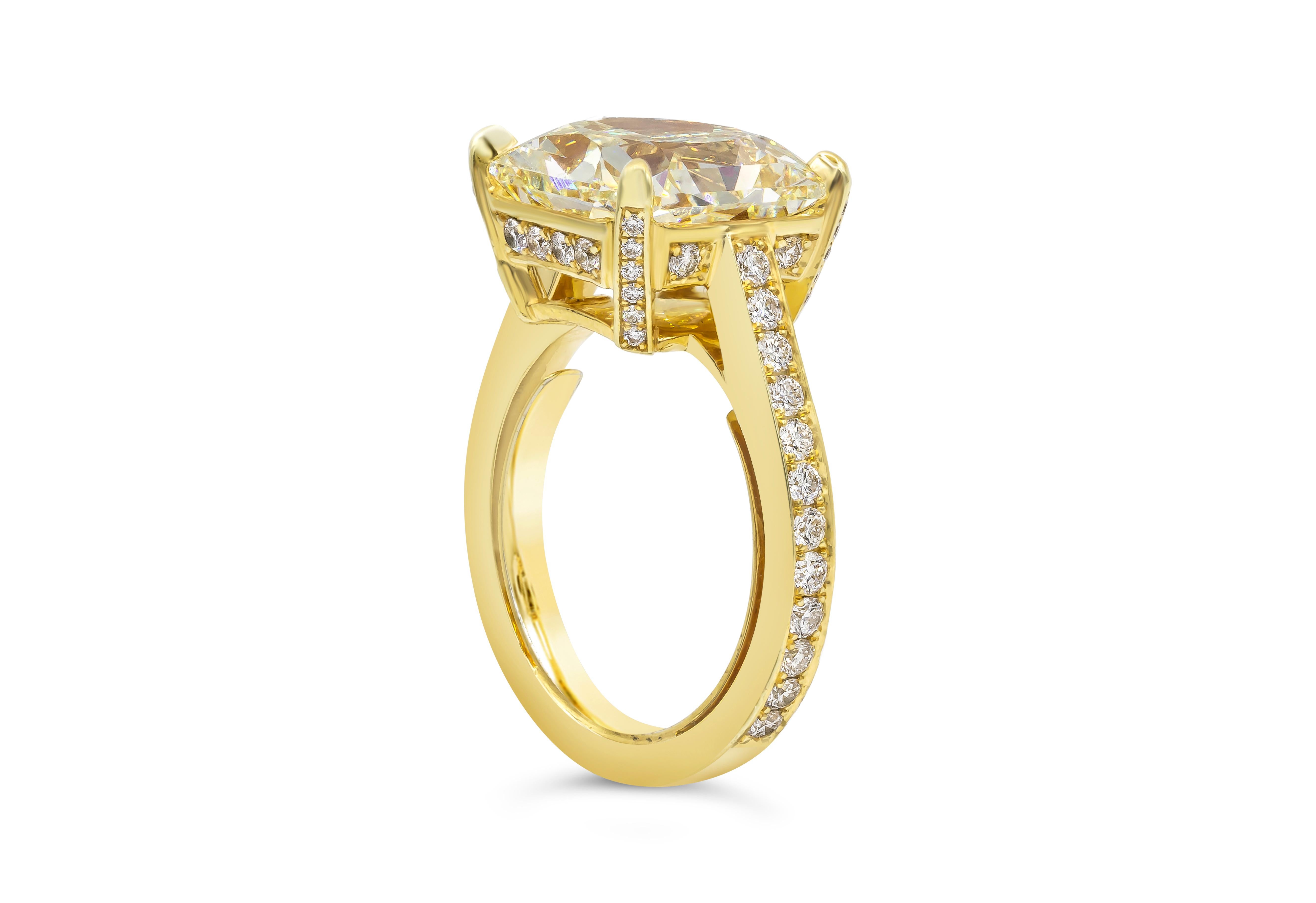 Timeless and classic pave engagement ring showcasing a vibrant 8.07 carat radiant cut diamond certified by GIA as fancy yellow color, VS1 in clarity, set in a four prong 18k yellow gold basket. Accented by 60 pieces of brilliant round diamonds