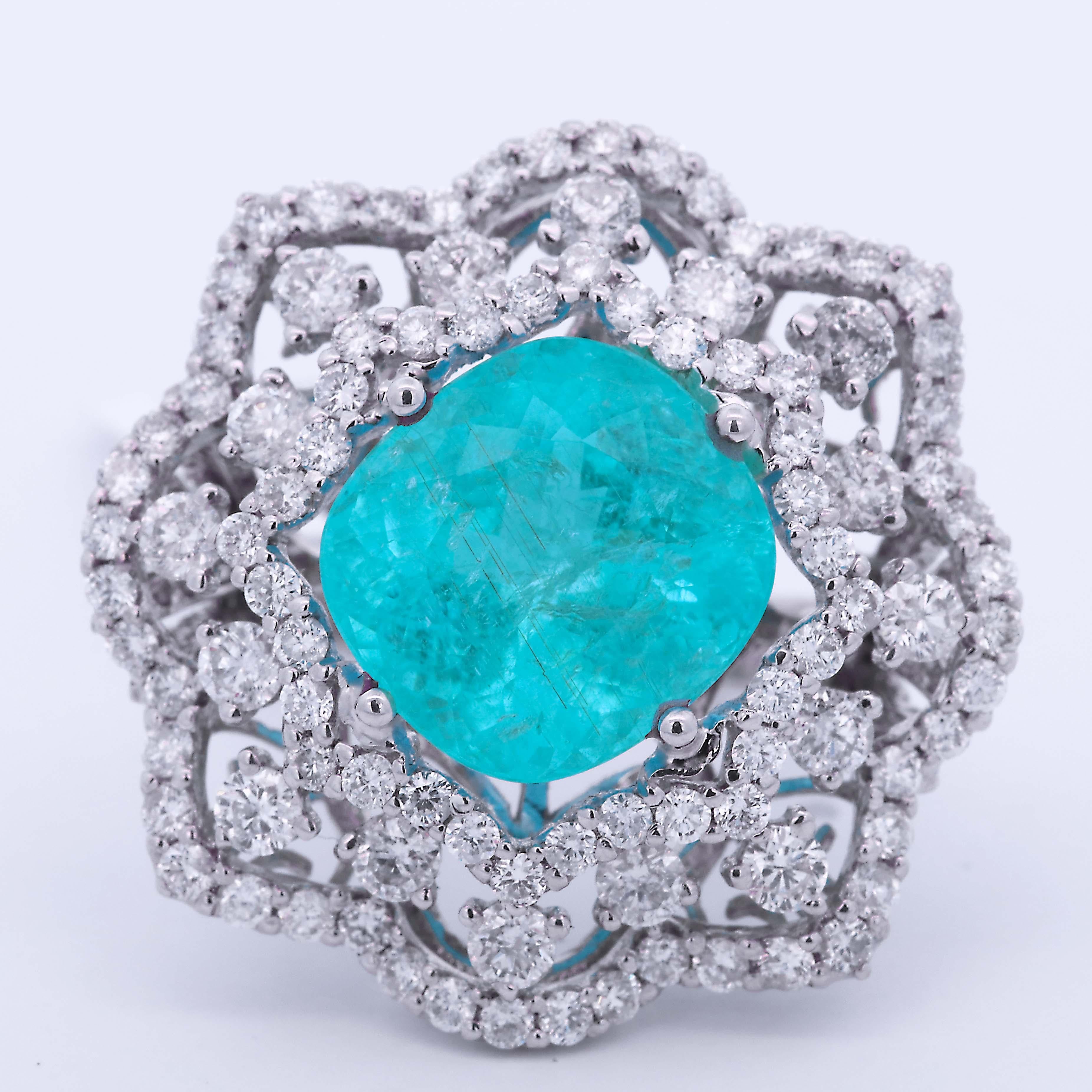 A stunning and vibrant GIA-certified 8.10 Carat Mozambique Paraiba, Tourmaline, and Diamond Gemstone Engagement Ring This beautiful 18-karat white gold ring features an exquisite paraiba tourmaline center stone. It is accented by an intricate design