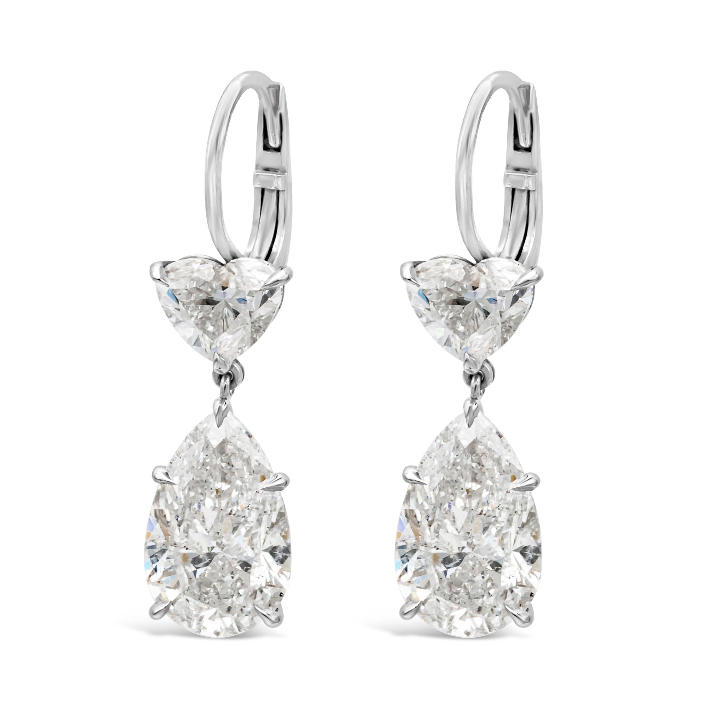 A classy and well crafted pair of high end dangle earrings featuring GIA certified pear shape and brilliant heart shape diamonds elegantly suspended to each other. Pear shape diamonds weigh 6.07 carats total, F-G color and I2 in clarity. Heart Shape