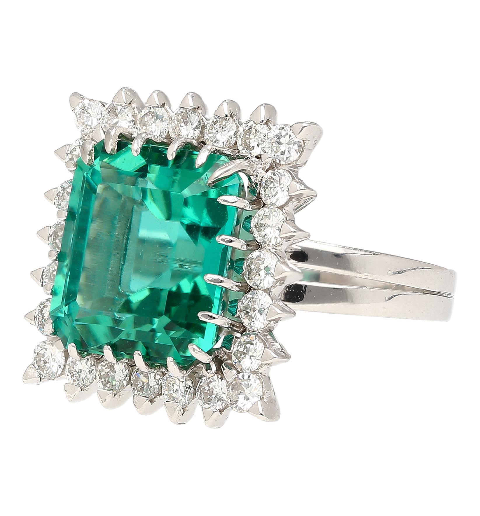 Bague carrée en platine avec tourmaline certifiée GIA de 8,17 carats et halo de diamants. Cette bague élégante et étincelante est ornée d'une pierre centrale en tourmaline d'une couleur verte éblouissante et d'une teinte bleutée. La pierre centrale