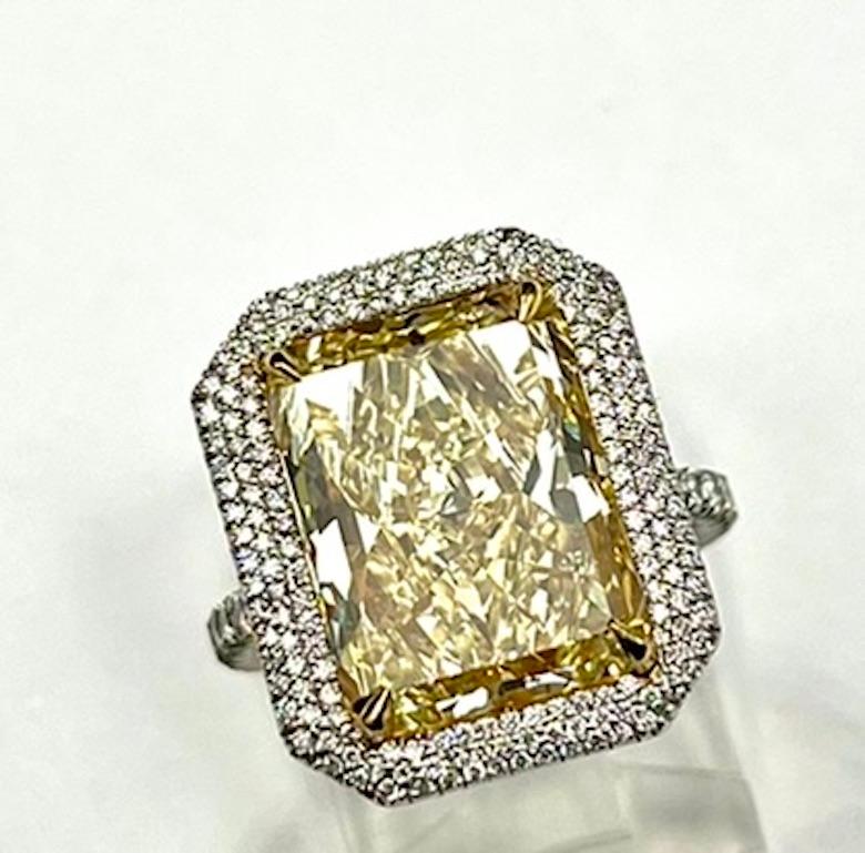 This is a truly stunning and impressive ring. It faces up like at least a 10Ct Diamond and the delicate double halo setting enfolds the diamond beautifully. The yellow color borders on the intense scale and is evenly saturated. The yellow hue of