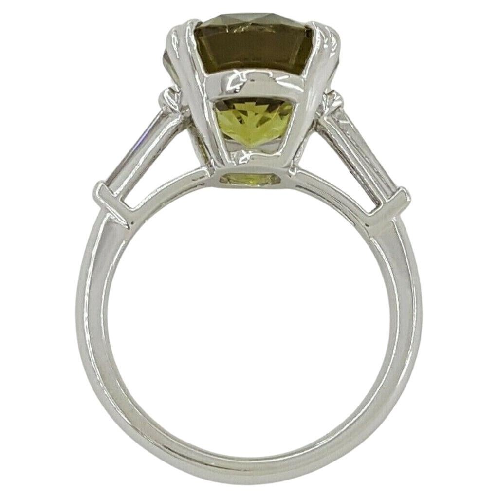This exquisite engagement ring is a remarkable showcase of craftsmanship and unique gemstone selection, featuring a total weight of 8.71 ct. Crafted in platinum, a metal known for its strength and purity, the ring itself weighs 8.7 grams and is