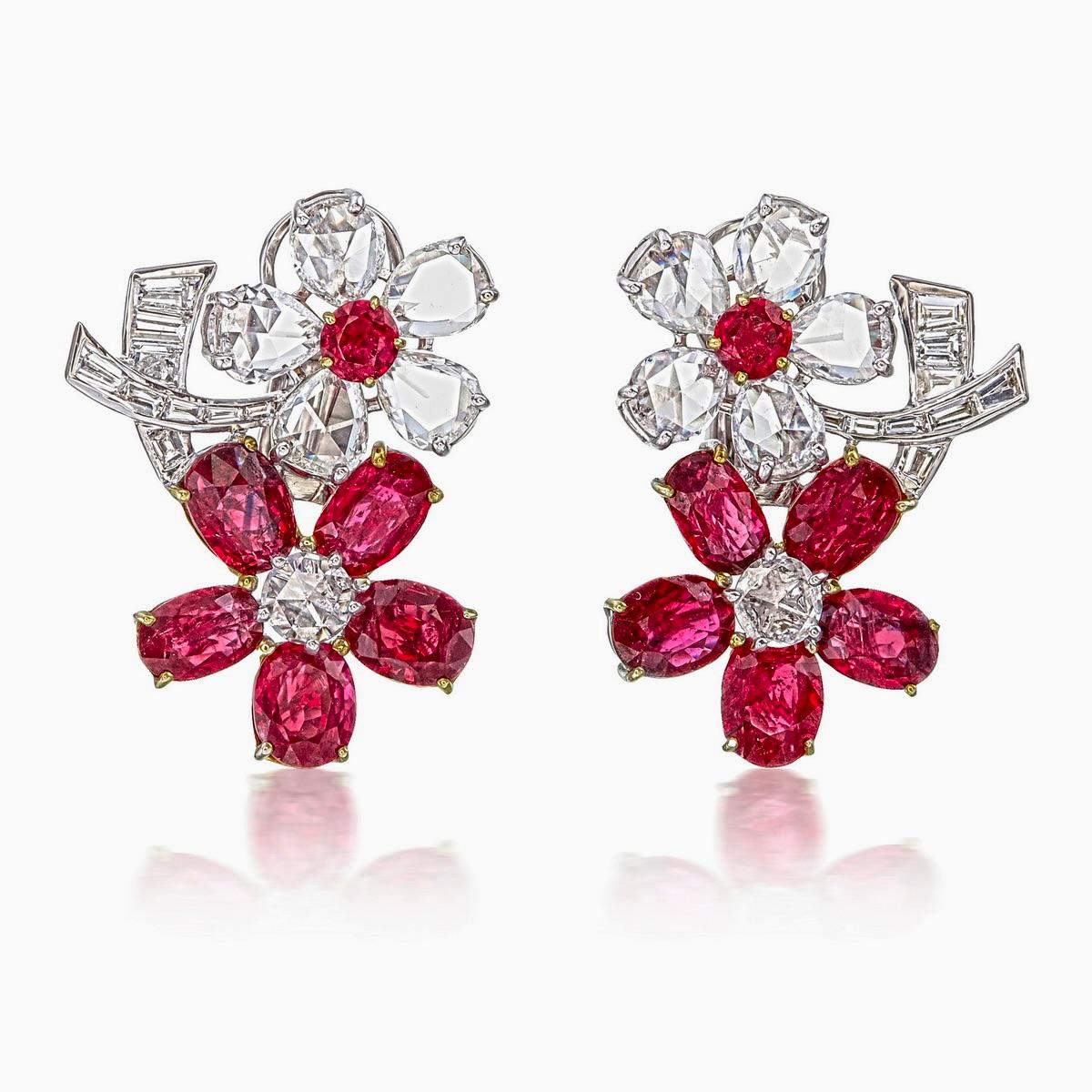 These extraordinary earrings feature an 8.43-carat No Heat Burma Pigeon Blood ruby, certified by GemResearch Swisslab (GRS), certificate number GIA2497150924, known for its exceptional color and rarity. 

Surrounding the ruby are 3.87 carats of
