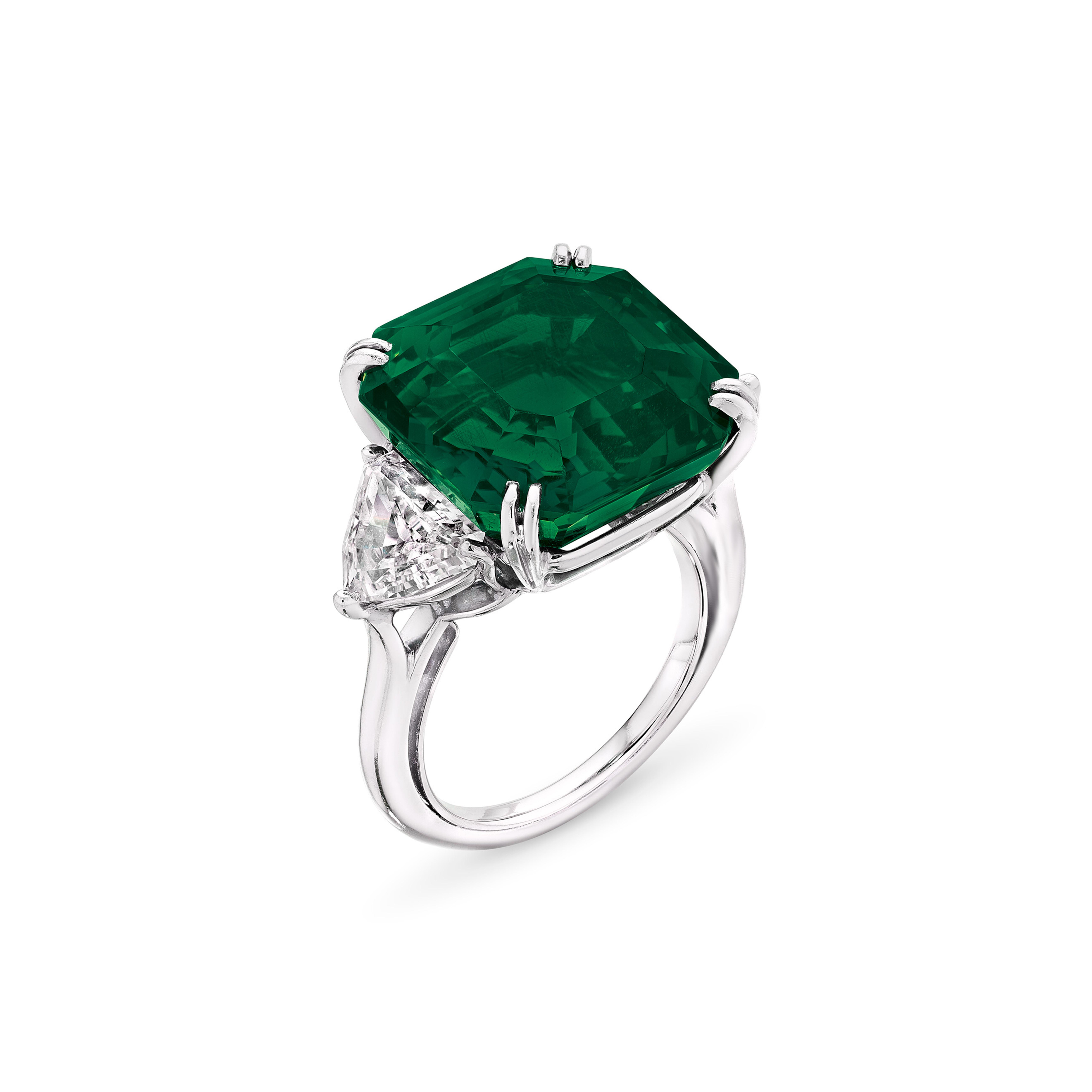 Indulge in timeless elegance with this breathtaking ring, featuring a substantial 8.46 carat emerald-cut vivid green, certified by GRS. 

Accompained by a dazzling pair of trillion cut diamonds, this masterpiece is mounted in platinum for a