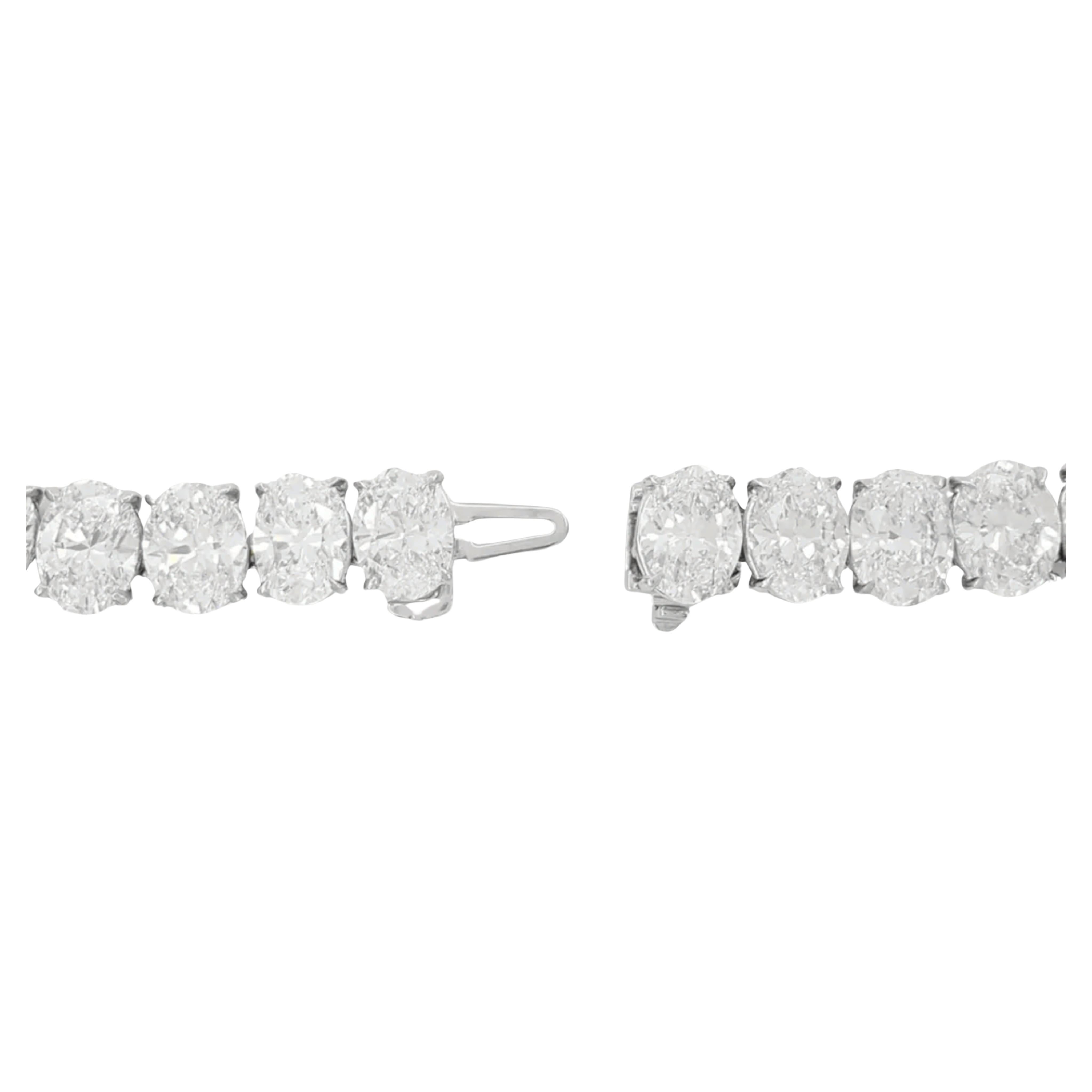 An exquisite 85.1 ct Oval Brilliant Cut Diamond Riviera Tennis Line Necklace, measuring 16 inches in length. This stunning necklace weighs 57.2 grams and features a breadth of 13.4 mm in the middle, narrowing to 7.7 mm at the clasp, with a thickness