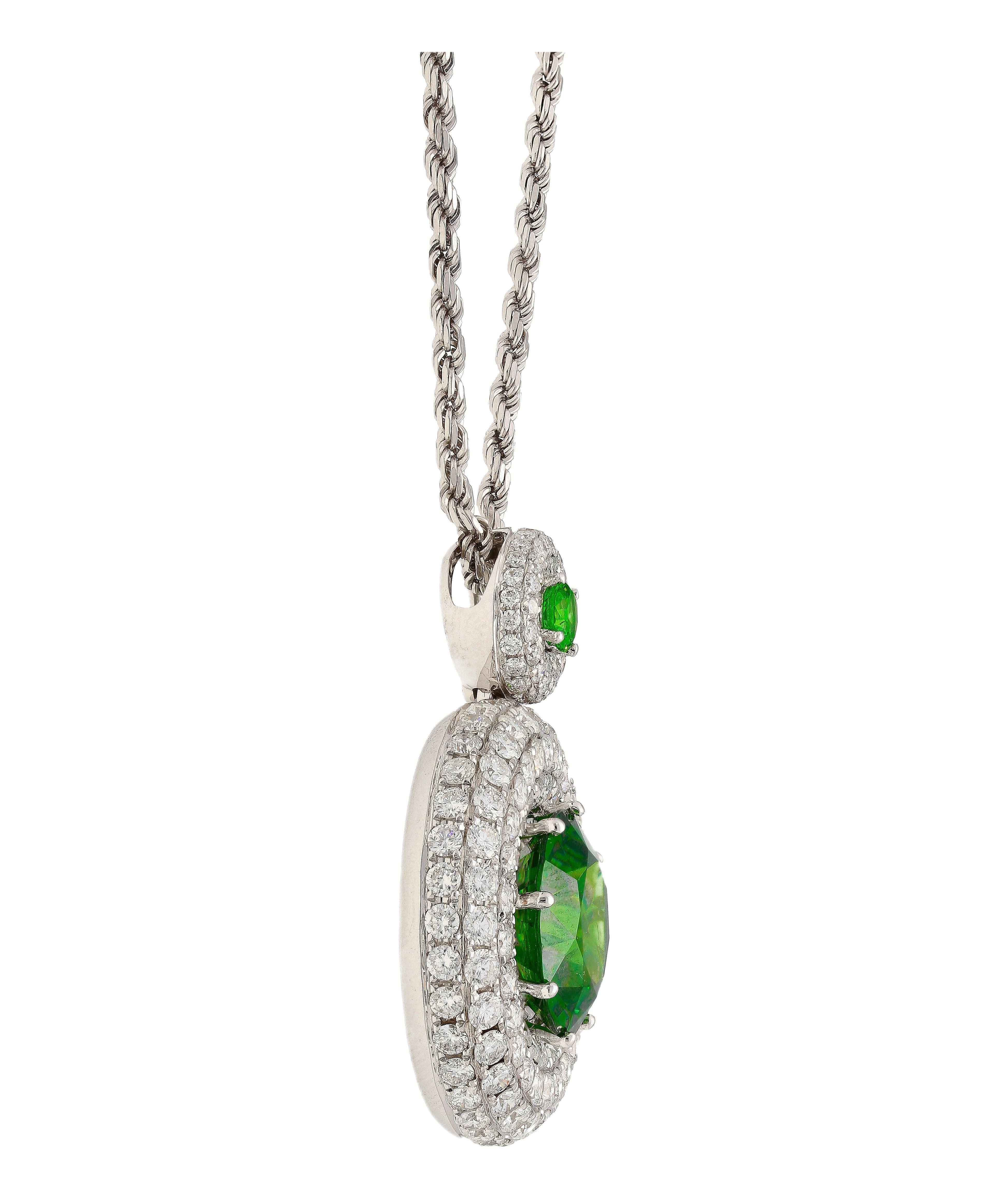 GIA certified Green Demantoid and diamond halo pendant necklace in 18k white gold. Featuring a 8.58 carat round cut Andradite Garnet Demantoid and a smaller companion Demantoid of 0.30 carats. Encompassed by 162 eye clean natural diamonds forming a