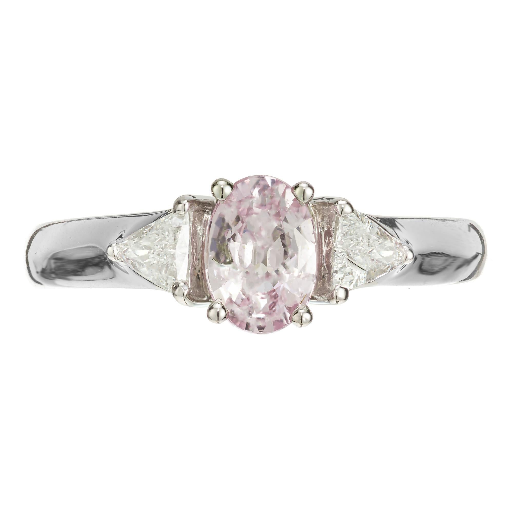 Pink sapphire and diamond engagement ring. GIA certified oval natural light pink/purple center sapphire with two trilliant cut side diamonds, set in a three-stone platinum setting marked NK. We are not familiar with this maker.

1 oval light pinkish