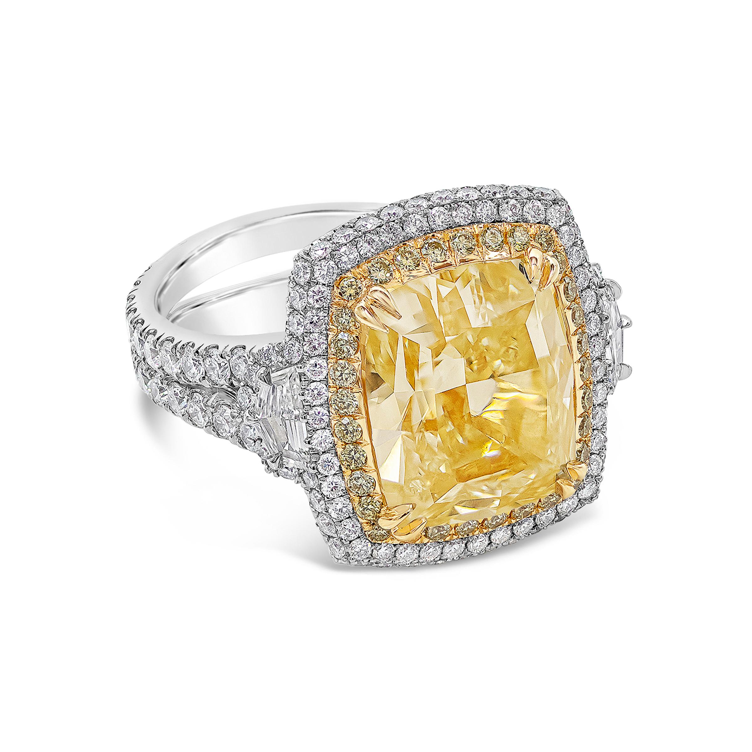 A beautiful ring made with impeccable craftsmanship. Features a GIA certified 8.77 carat Light Yellow Diamond, VS in Clarity. Set in a double-halo basket of yellow and white diamonds. Flanking the center diamond are two epaulette diamonds. Accent