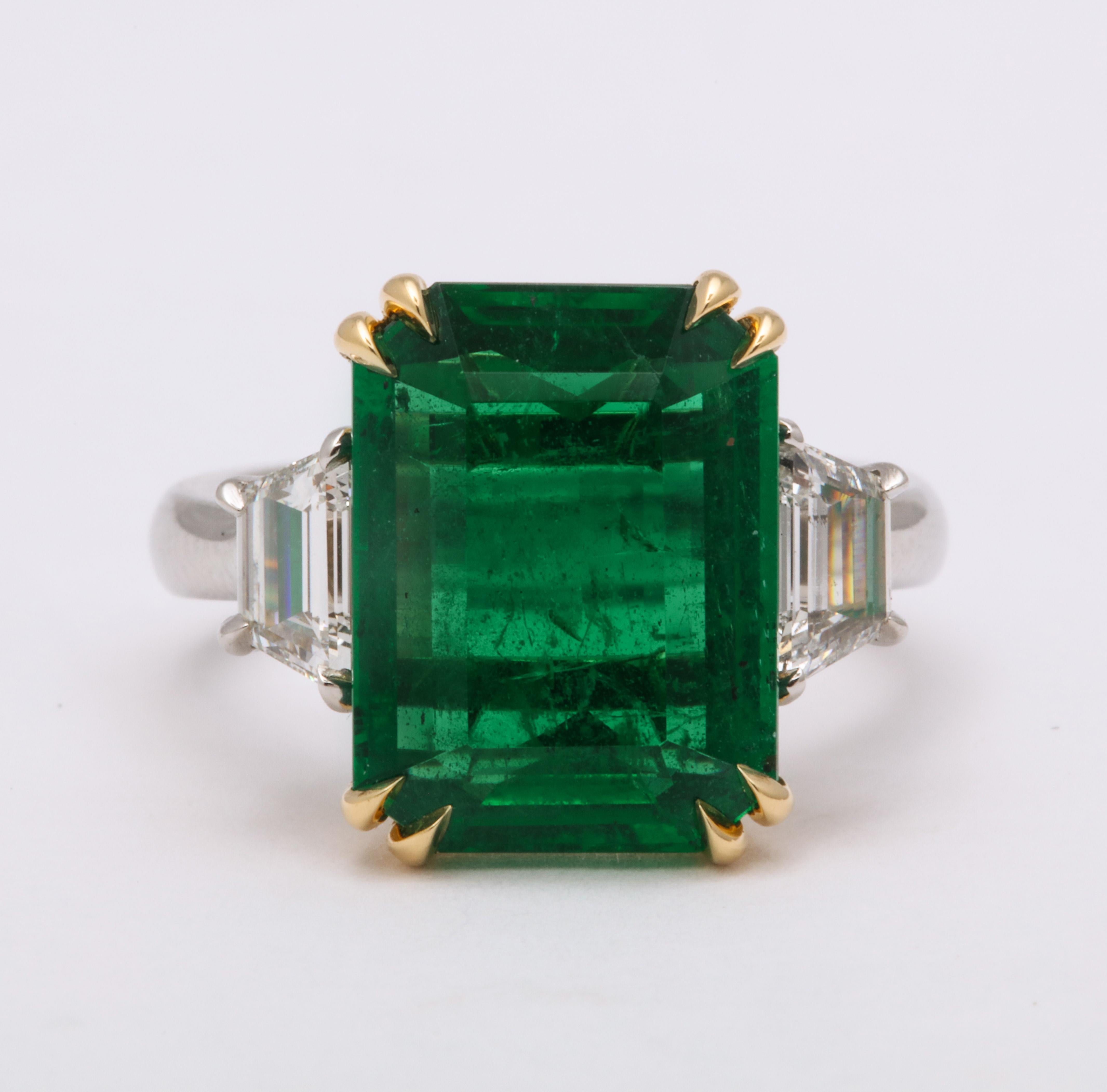 
A beautiful Green Emerald!

The perfect elongated shape, this GIA certified 8.81 carat Emerald is set with .88 carats of step cut trapezoid white diamonds. 

An impressive and wearable size. 

Custom made platinum and 18k yellow gold mounting.

The