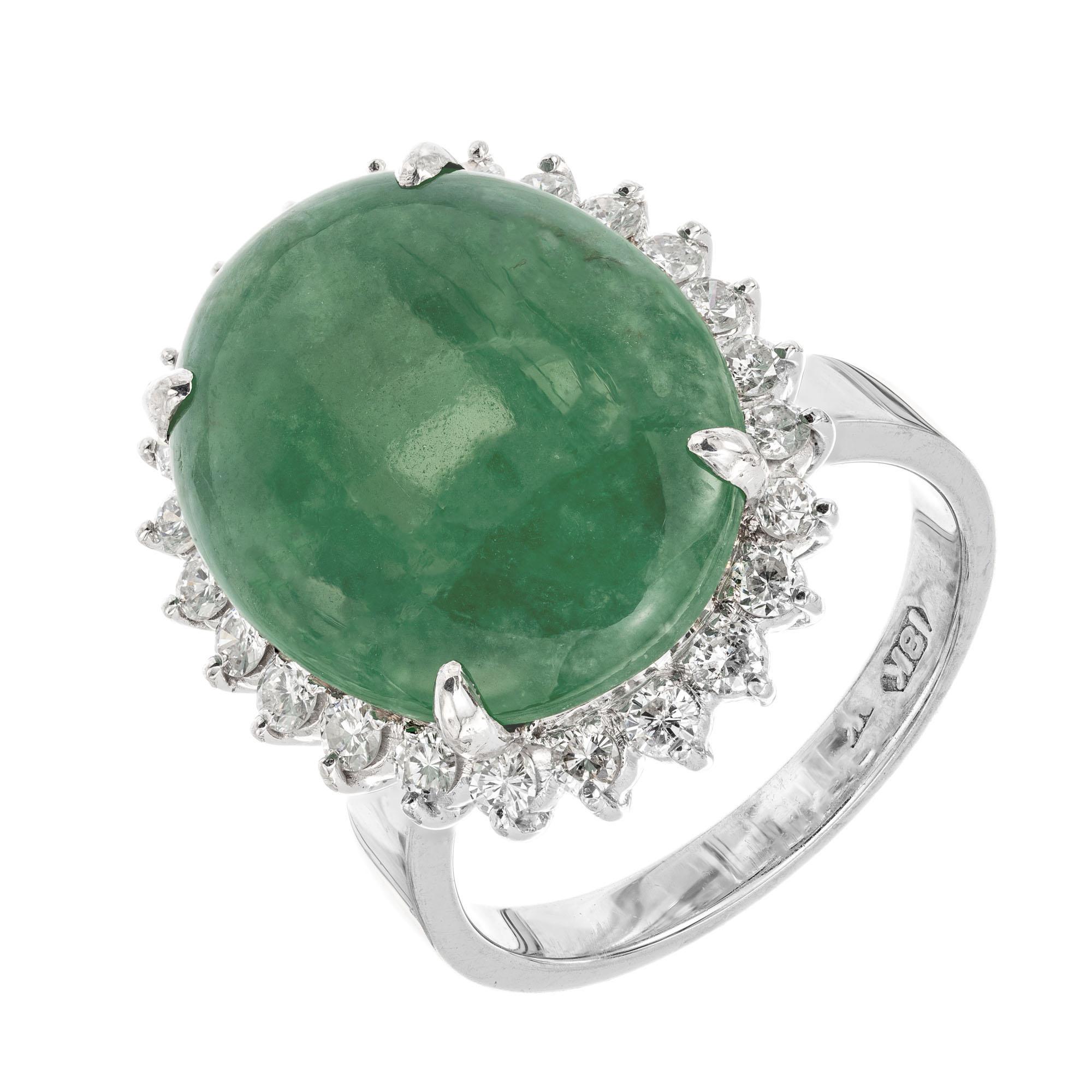 Oval jade and diamond cocktail ring. GIA certified natural untreated A grade jadeite jade center oval cabochon with a halo of round brilliant cut diamonds in a handmade 18k white gold ring.

1 oval cabochon green jade, approx. 8.95cts GIA