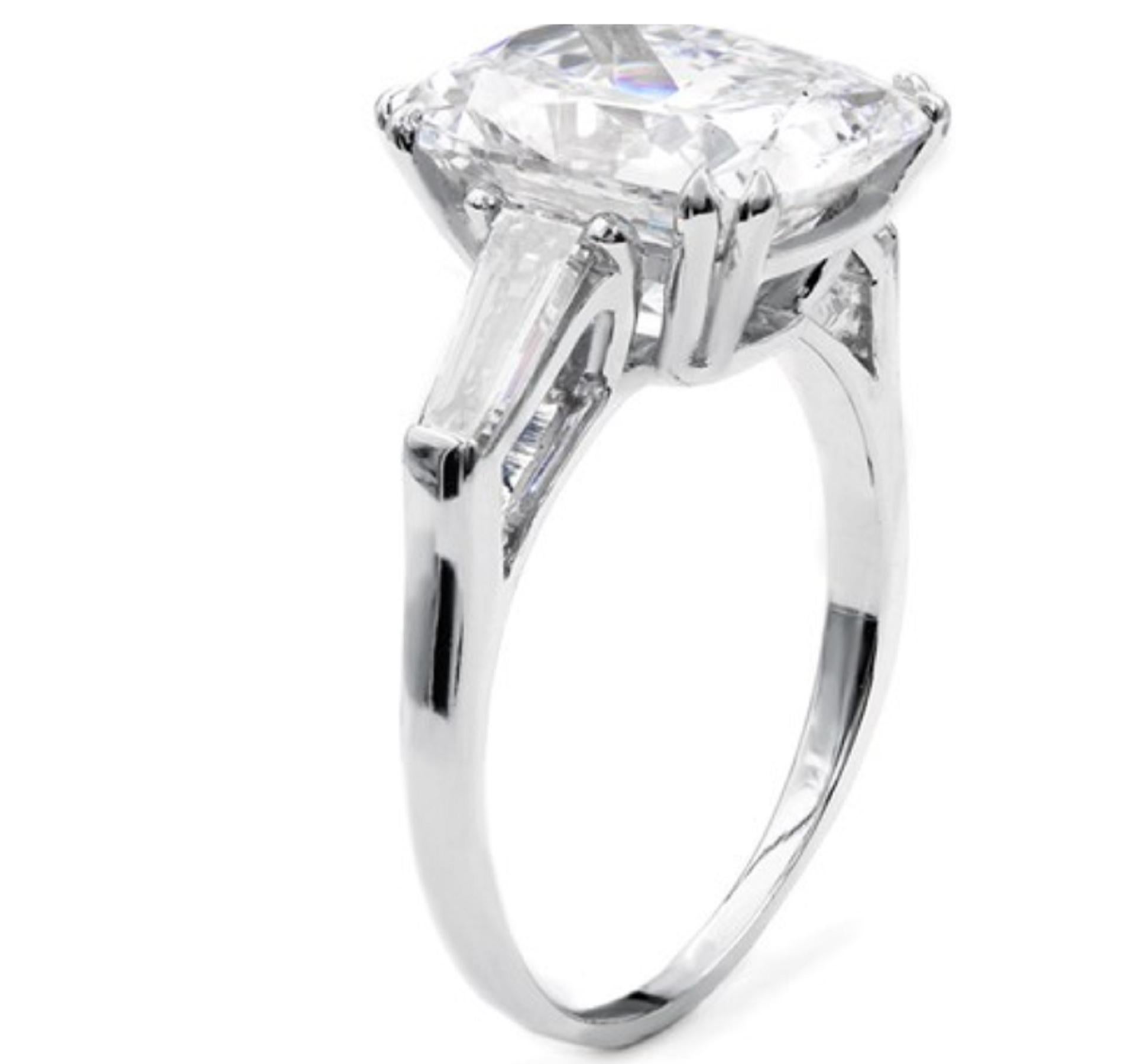 An exquisite brilliant cushion diamond with two tapered baguette diamonds and is mounted in solid platinum the total carat amount is 9 carats
the main stone weight is 9 carats
has D Color



