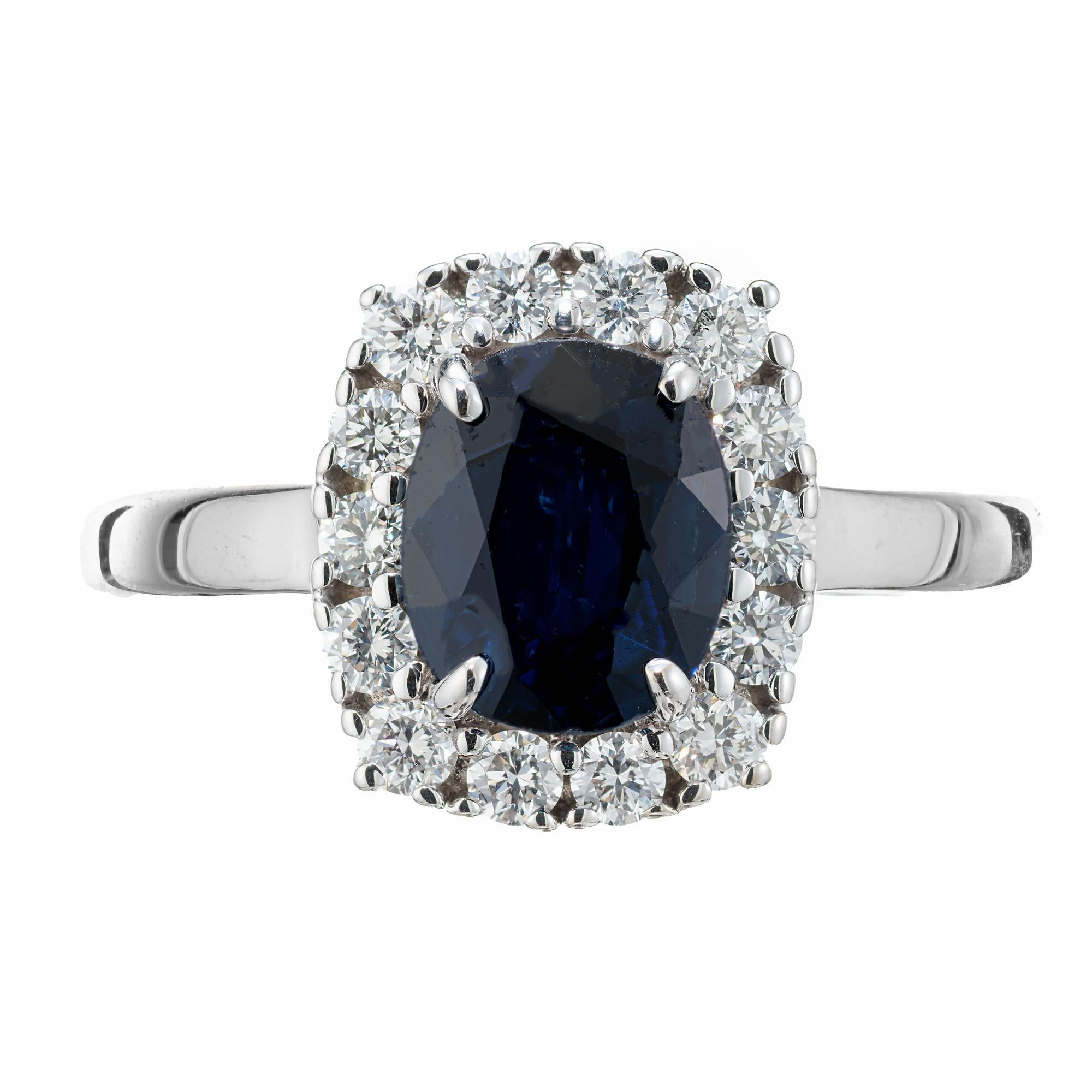 Blue oval sapphire diamond engagement ring. This GIA certified natural, not heat, .90ct. oval deep blue center sapphire is accented with a halo of 14 round brilliant cut, near colorless diamonds in a 14k white gold split shank setting. This ring is
