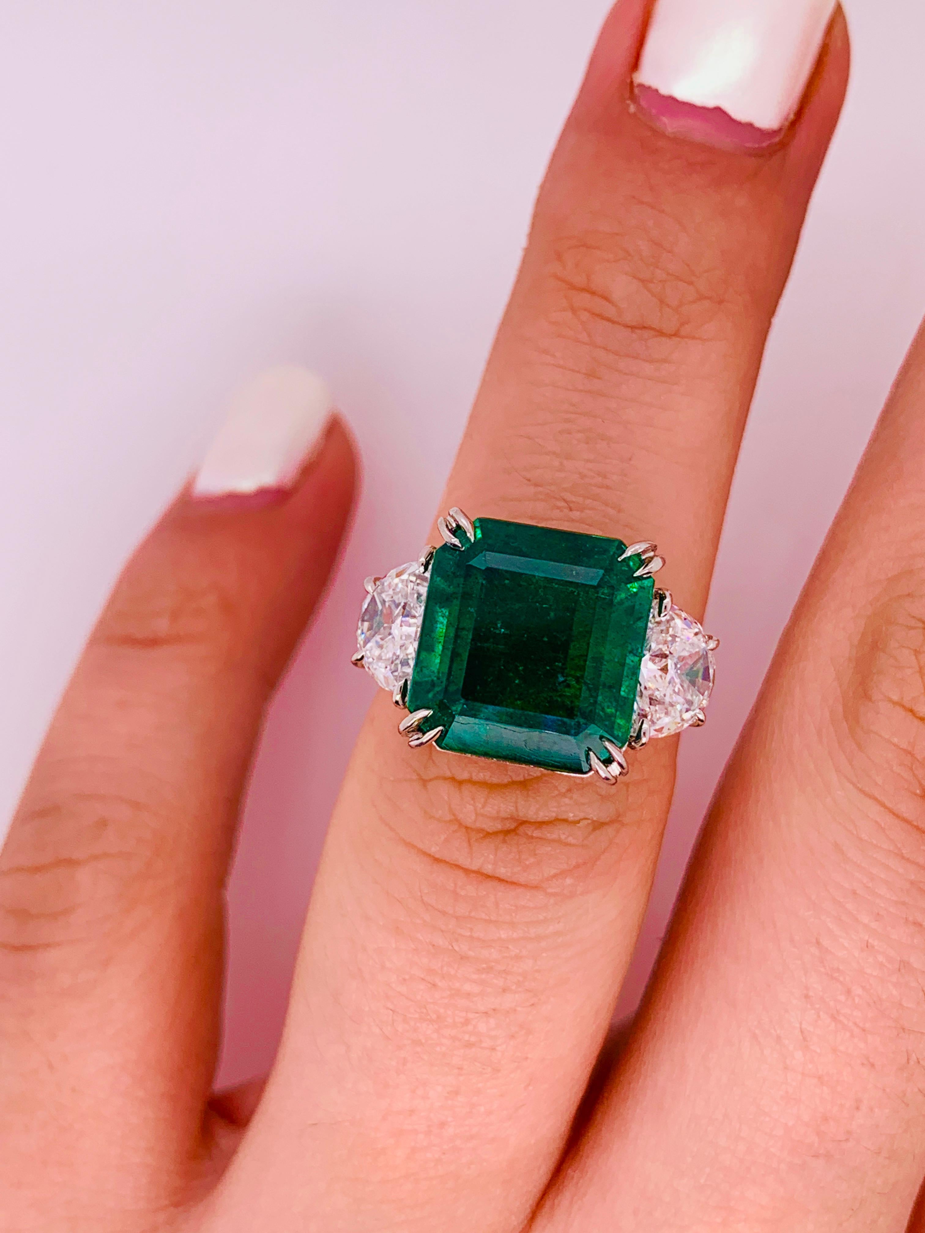 Magnificent Green emerald and diamond ring set with the finest quality half moon diamonds in Platinum. 

The center stone is 9.79 Carats Zambian Emerald cut Emerald, very fine quality, vivid green color, set with 1.68 Carats of half moon diamonds.