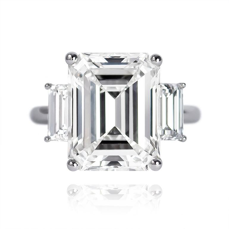 This ring fit for royalty features a GIA certified 9.10 carat Emerald cut diamond of I color and VS1 clarity... Set in a signed Trabert & Heffner platinum ring, the center stone is flanked by a pair of beautifully matched side stones = 1.50 ctw.