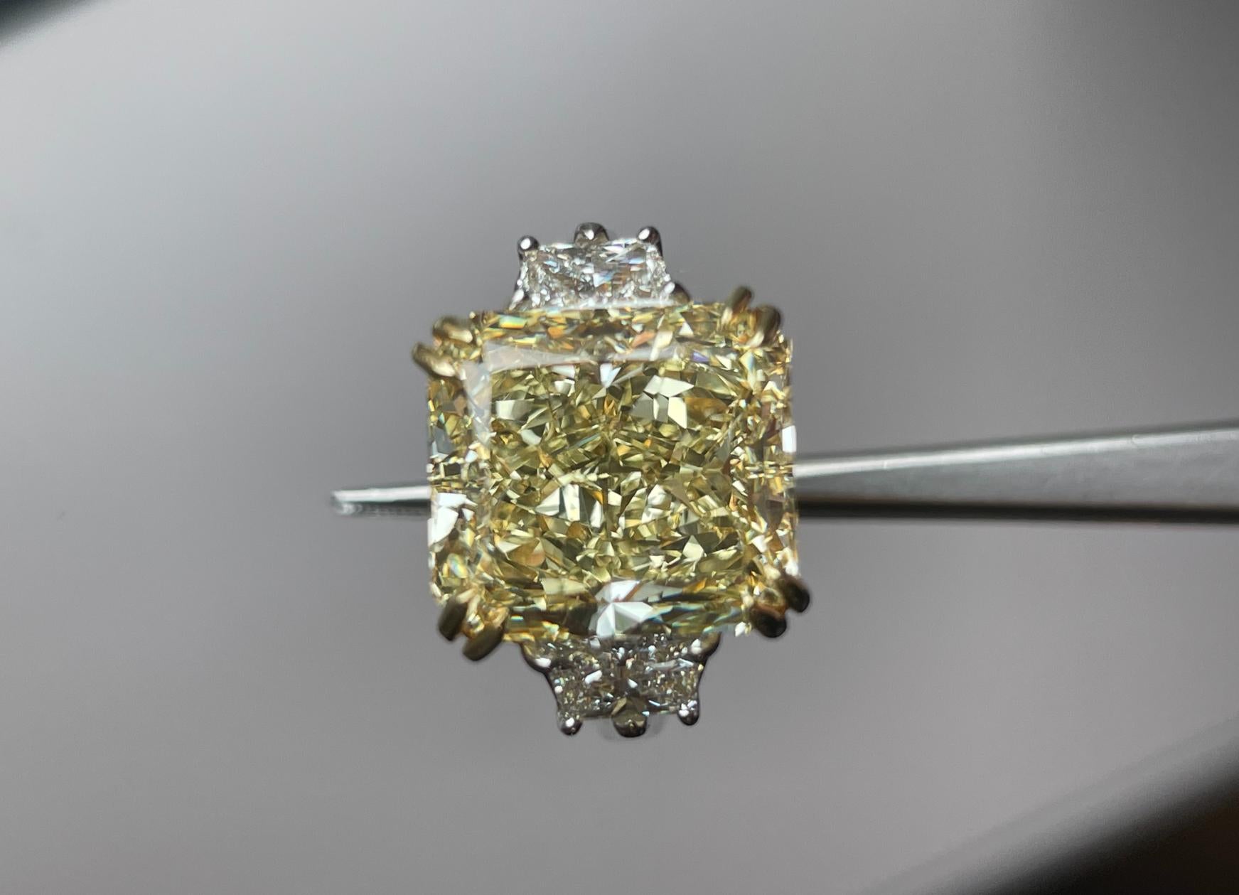 Extraordinary 9.13 Carat Fancy Yellow Radiant Cut Engagement Ring 

Setting:
Platinum / 18KY 

Center Stone: GIA Certified Fancy Yellow
Carat Weight: 9.13
Clarity: VS2

Side Stones: Trapezoid Diamonds 
Color: F-G
Clarity: VS
Cut: Excellent
The total