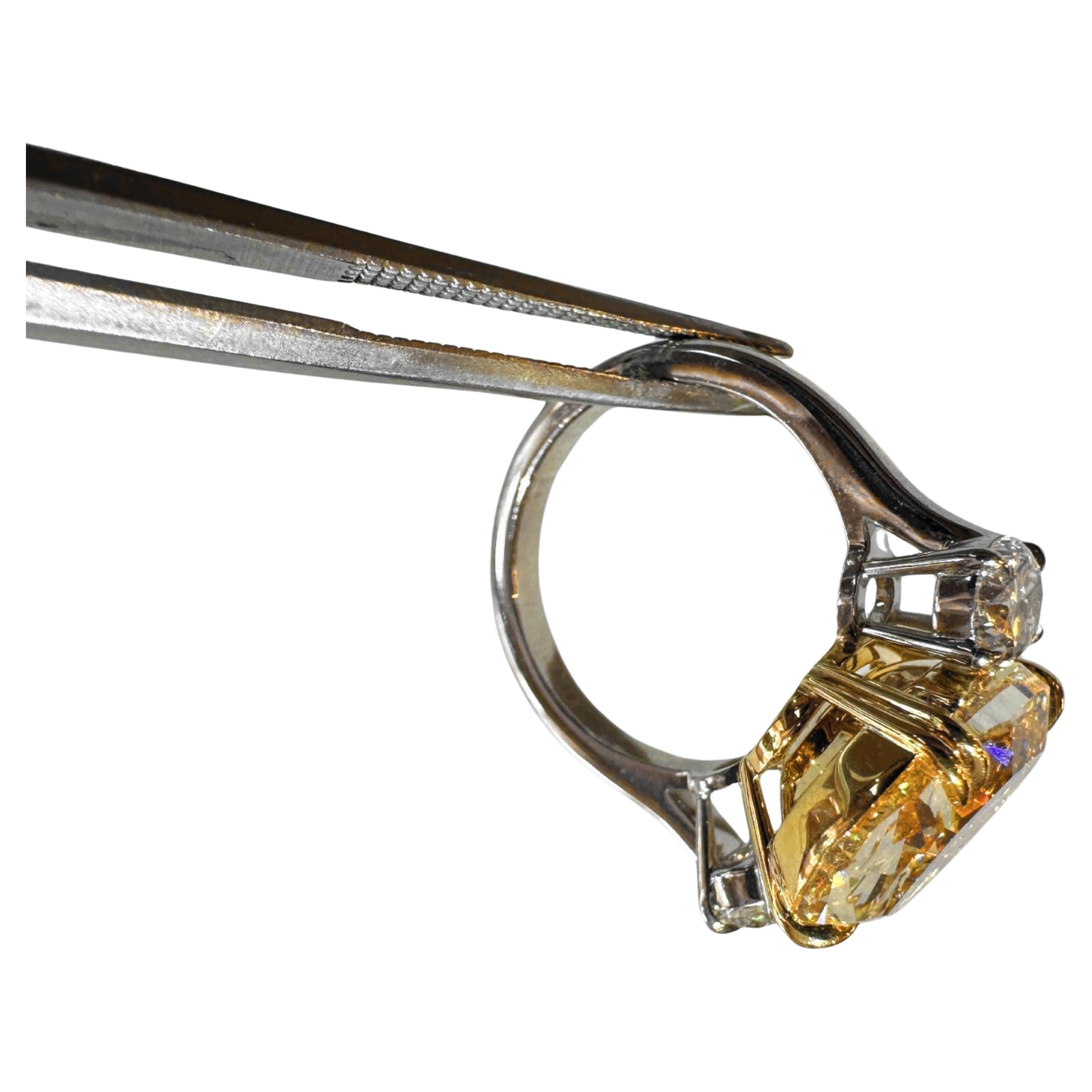 exquisite beauty of this striking engagement ring, featuring a stunning 9.13-carat oval cut fancy yellow diamond that commands attention as the captivating centerpiece. Secured by four hand-shaped claws, the soft, elegant lines of this diamond are