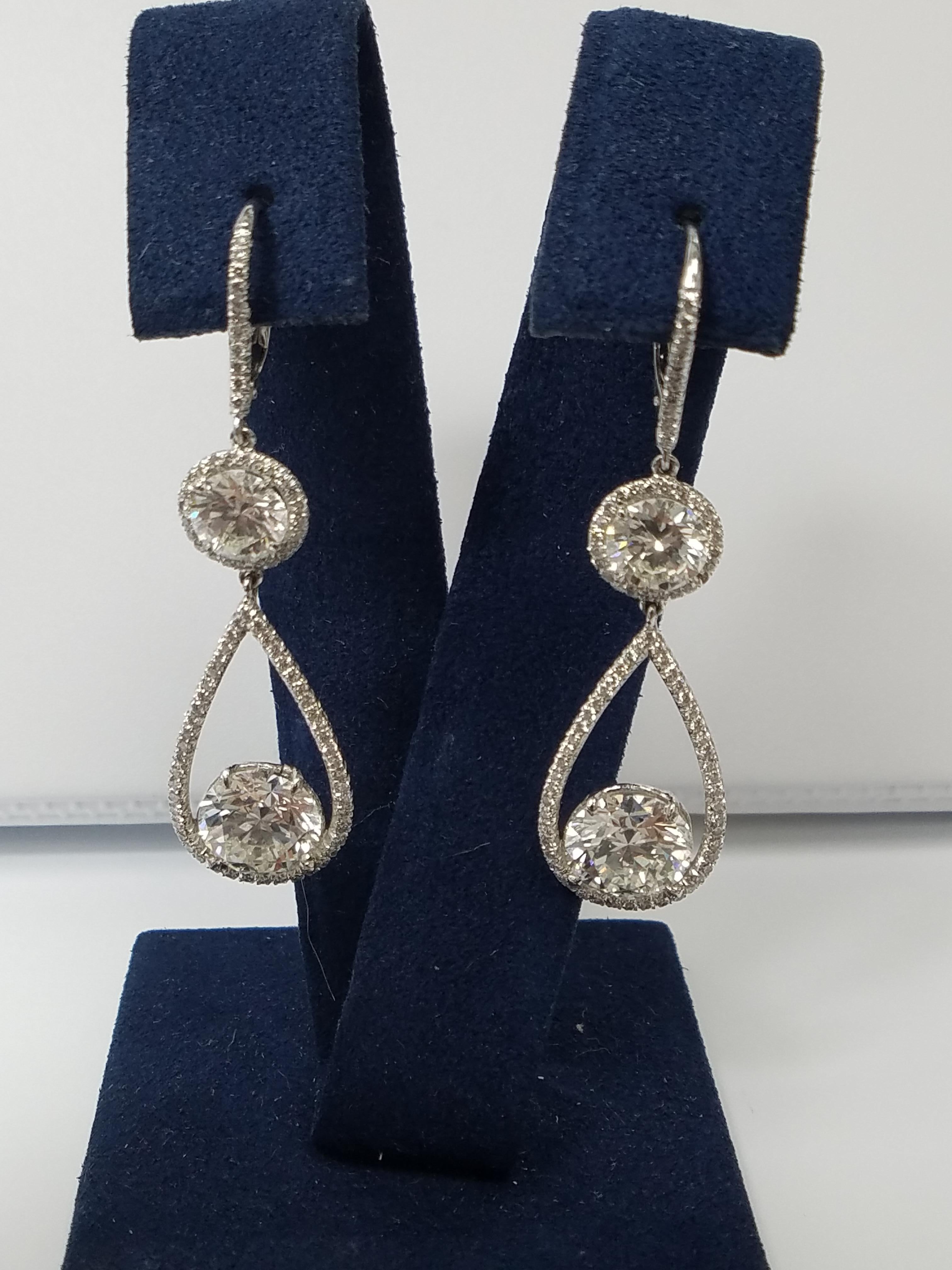 GIA Certified 9.19 total carat weight Diamond earrings.

Top stones are matching 1 carat each each GIA certified and bottom bigger stones are 3 carat each also GIA certified. Has an additional 1 carat of diamonds set in the platinum setting. All the