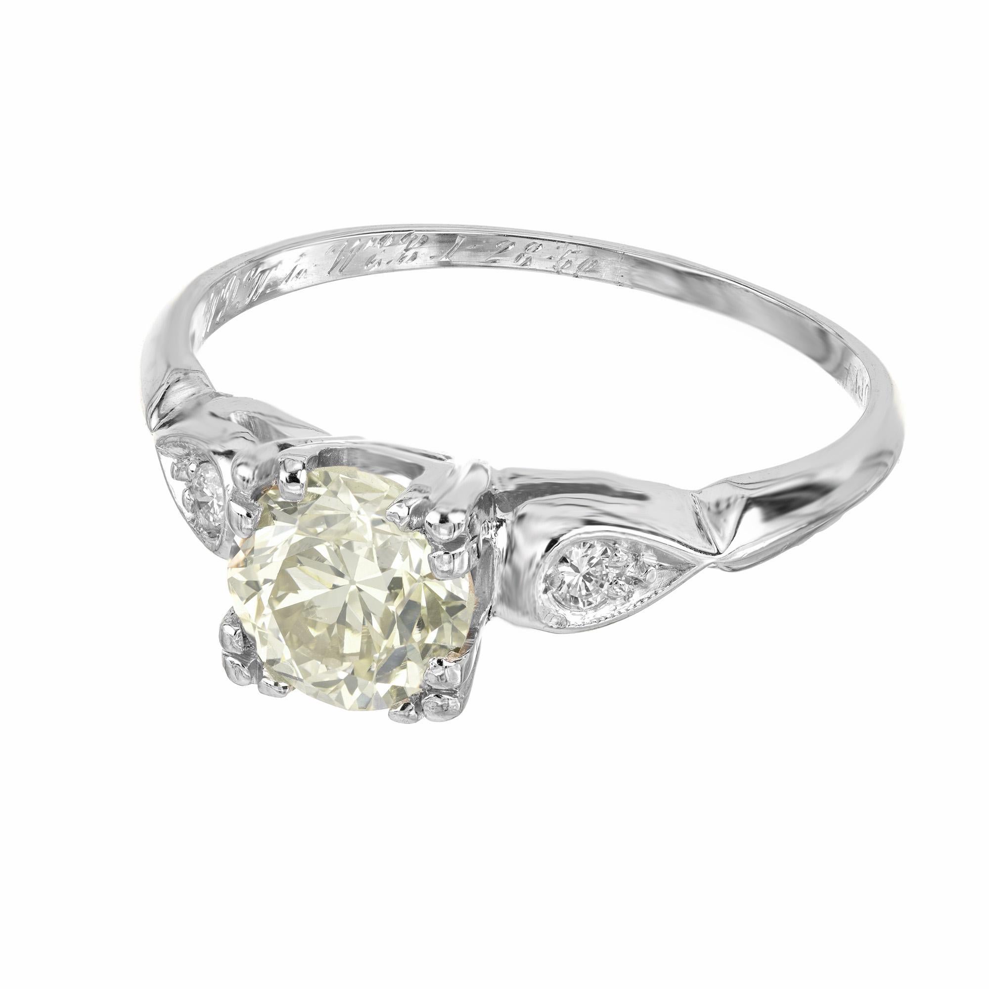 This 1920's Art Deco GIA Certified .93ct diamond three stone platinum engagement ring is a testament to timeless elegance and precision craftsmanship. Mounted with a vibrant yellow old European cut center diamond that is nestled by two round cut