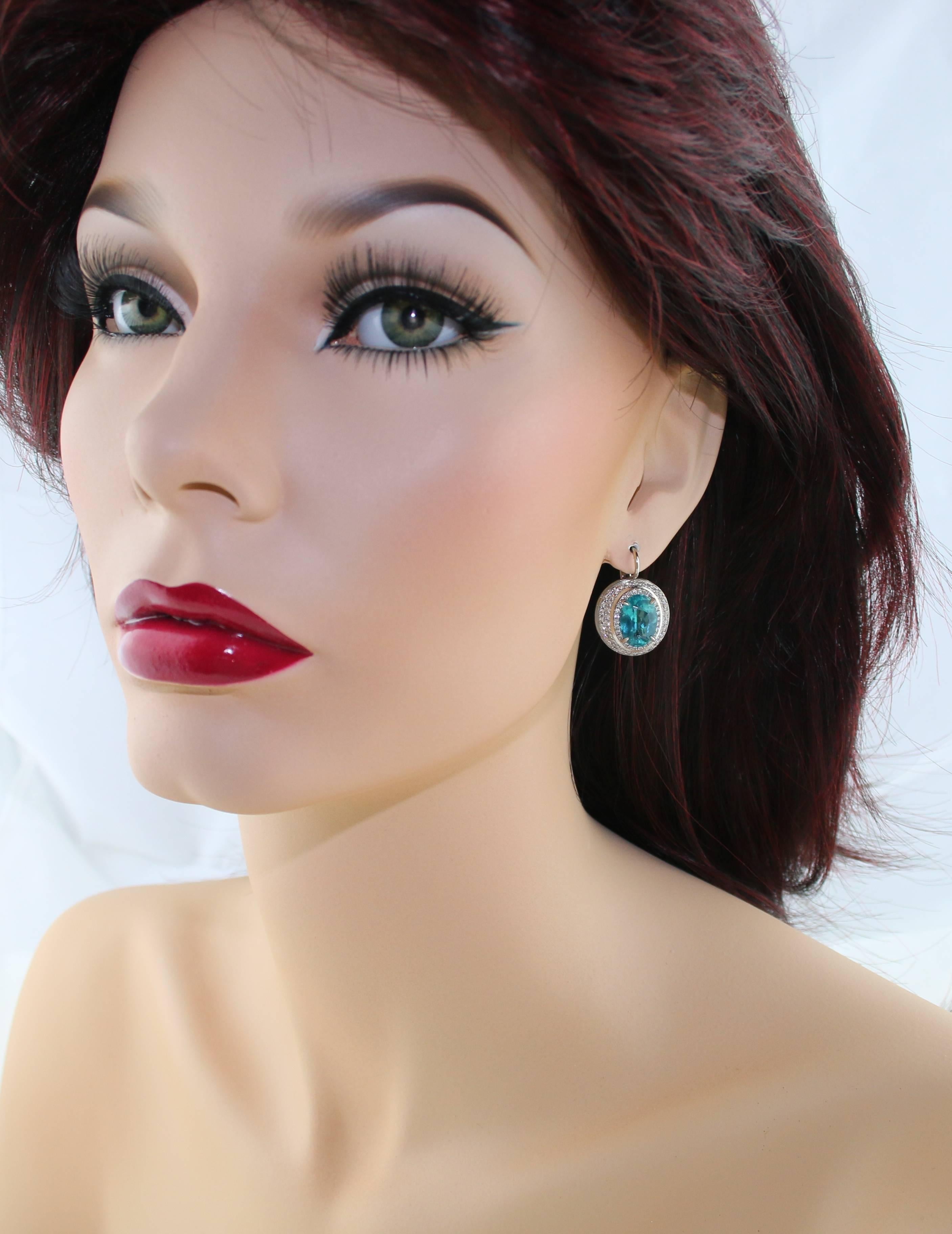 One of a kind Apatite Earrings
The earrings are 18K White Gold
The Center stones are Oval 4.65 Carats Apatite & 4.66 Carats Apatite
The stones are GIA certified
There are 1.77 Carats in Diamonds G VS/SI
The earrings measure 1