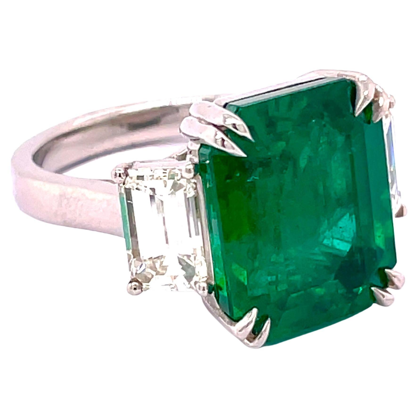 Spectacular GIA Certified 9.32 Carat Natural Emerald Radiant Cut 3 Stone Ring 

Setting:
Platinum

Center Stone:
Natural 9.32ct Emerald Radiant Cut 
 

Side Stones: Natural Emerald Cut Diamonds
Color: G-H
Clarity: VS
Cut: Excellent
The total