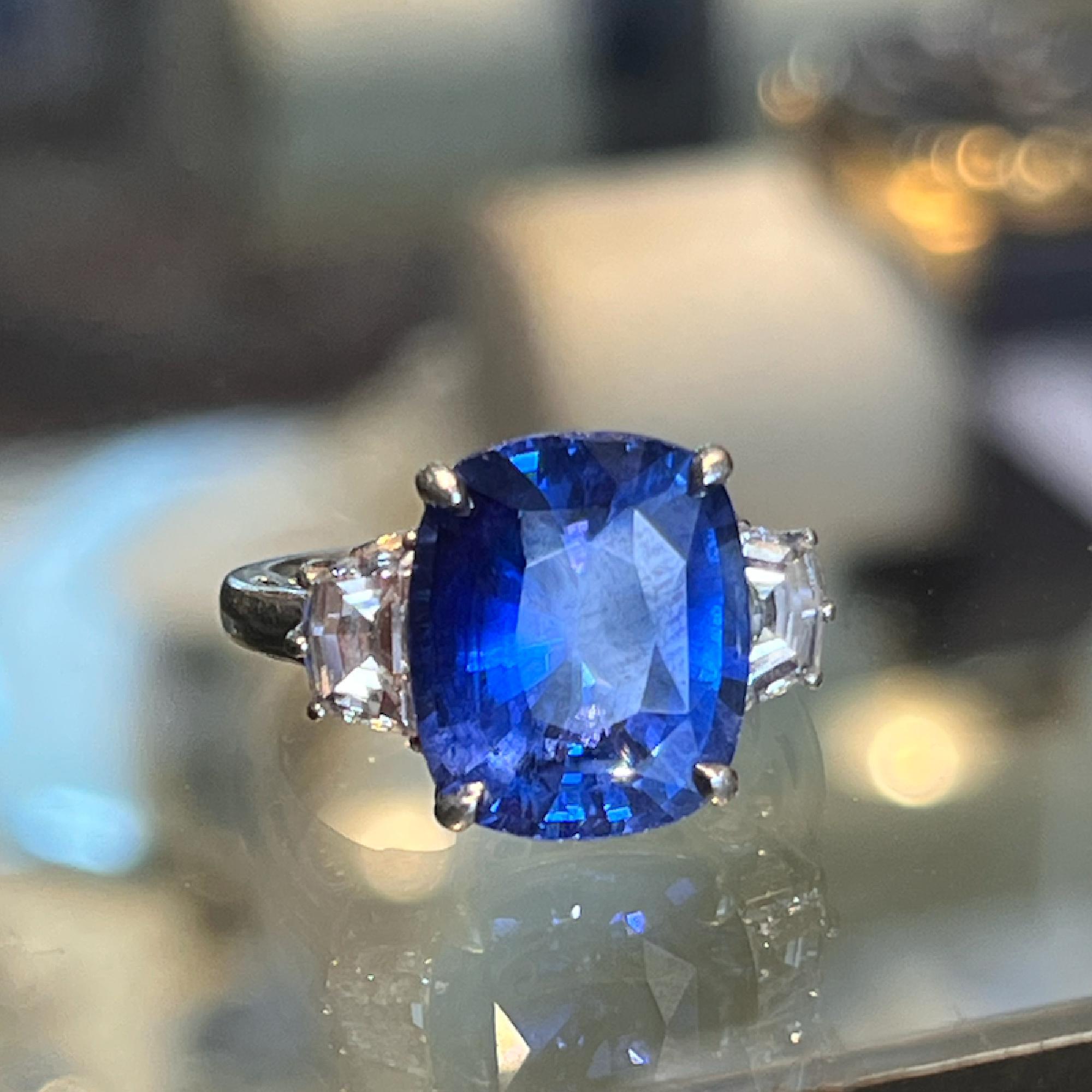 Platinum GIA Certified 9.35 Carat Ceylon Sapphire & Diamond Lady’s Three (3) Stone Ring. This Ring Contains (1) Cushion Cut Ceylon Sapphire Weighing Approximately 9.35cts, This Stone Measures 13.20mm x 11.15mm x 6.45mm. The Stone is Vibrant Blue in