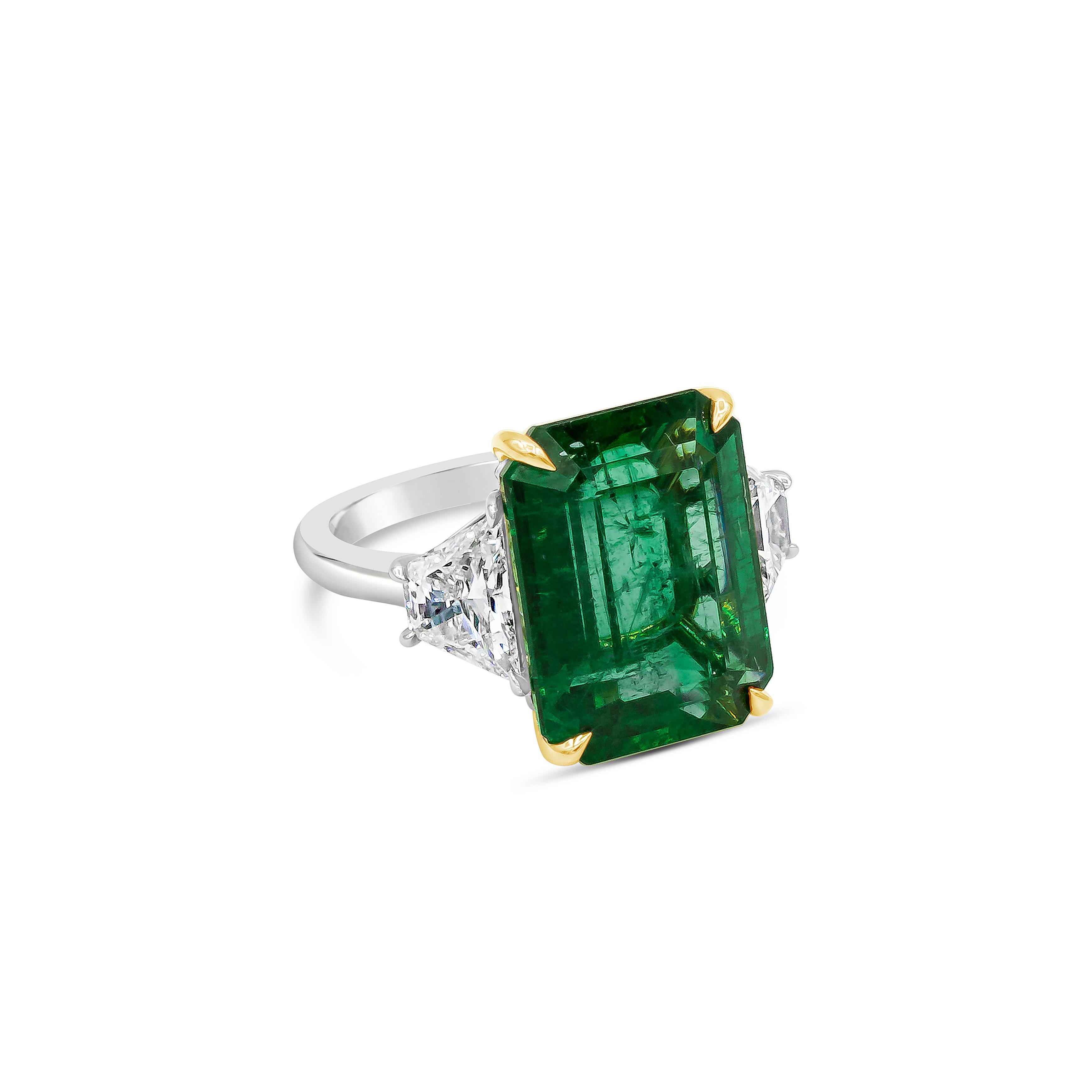Showcases a color-rich green emerald weighing 9.36 carat, flanked by two trapezoid diamonds weighing 1.43 carats total. Set in a rounded platinum mounting. Size 6.5 US (Sizable upon request).

Style available in different price ranges. Prices are
