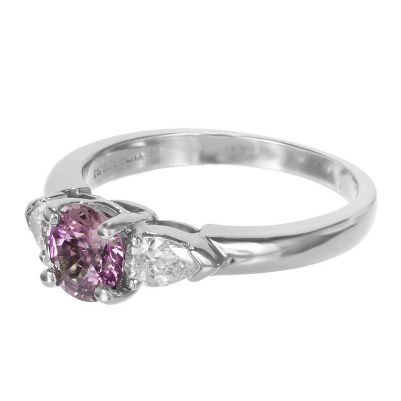 1950's Pink purple round sapphire and diamond engagement ring. GIA certified round European cut fancy intense center sapphire mounted in a platinum three-stone handmade engagement setting. Accented with 2 pear shaped side diamonds. The GIA has