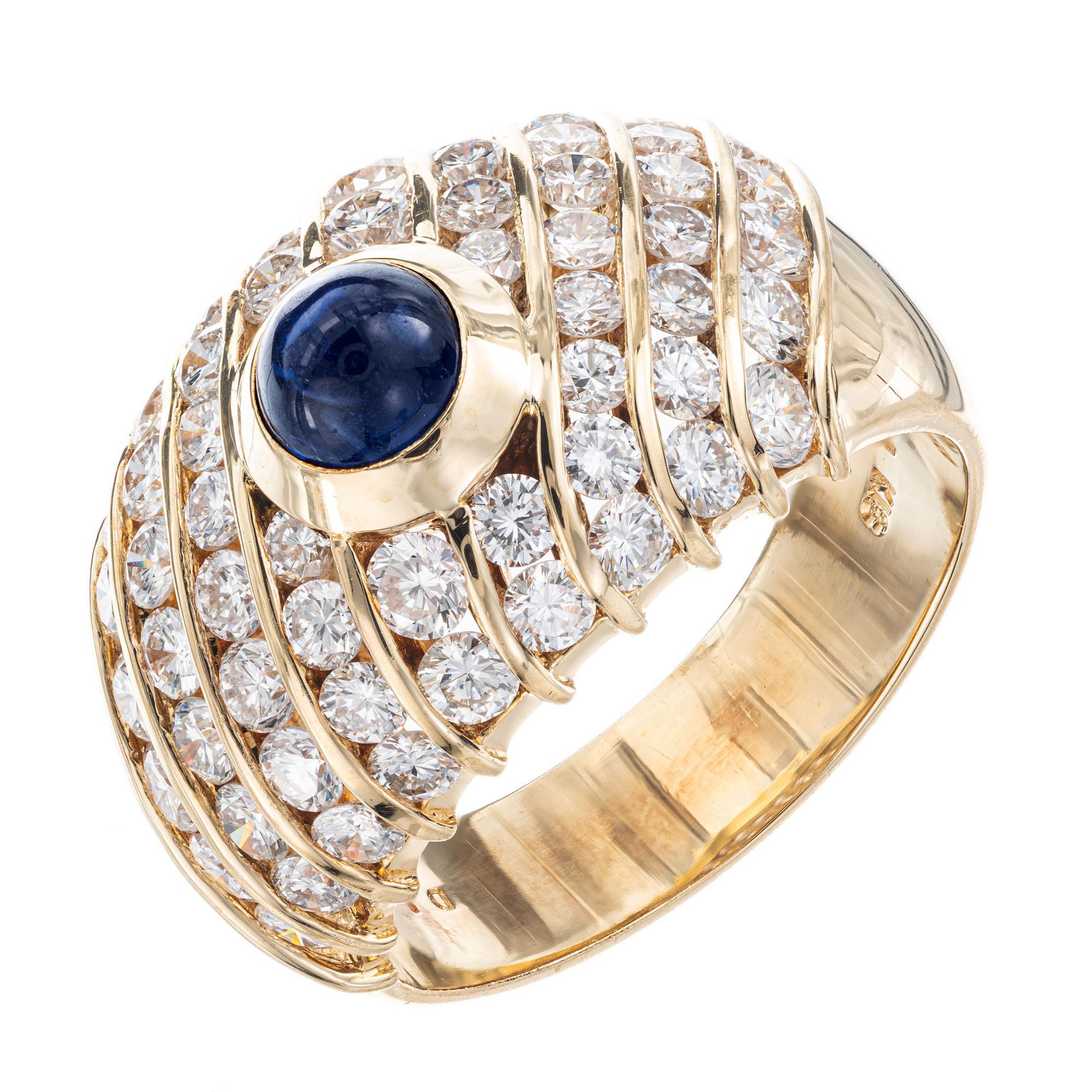Diamond and sapphire cocktail ring. GIA certified center cabochon center sapphire with 56 full cut round diamonds in a 18k yellow gold cluster setting. 

CMT Type 1 natural Sapphire simple heat only, one cabochon gem blue Sapphire, approx. total