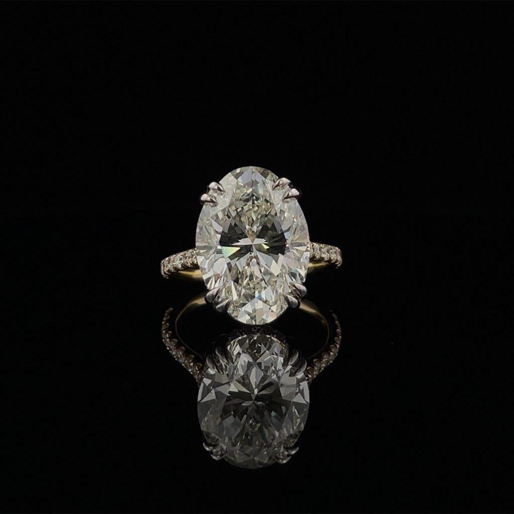 What a special, one of a kind piece ... 

This gorgeous ring is set with a 9.42CT Oval Cut Natural - 
K-VS1 in Quality (GIA Certified #2215154666) Diamond Center. The diamond is set in a 18K White Gold Double Prong Head and a Double Hidden Halo