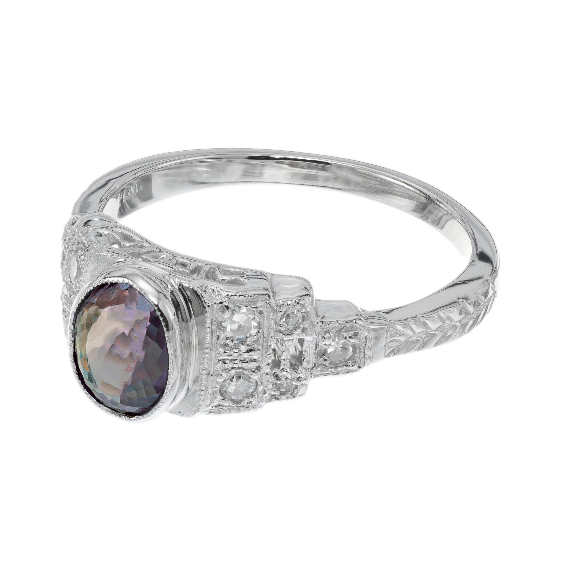 1920's Art Deco Alexandrite and diamond engagement ring. GIA certified oval center stone, .95 carats in a platinum setting with 10 round accent diamonds. The alexandrite is a color change stone, it has green, grey and red color tones. 

1 oval