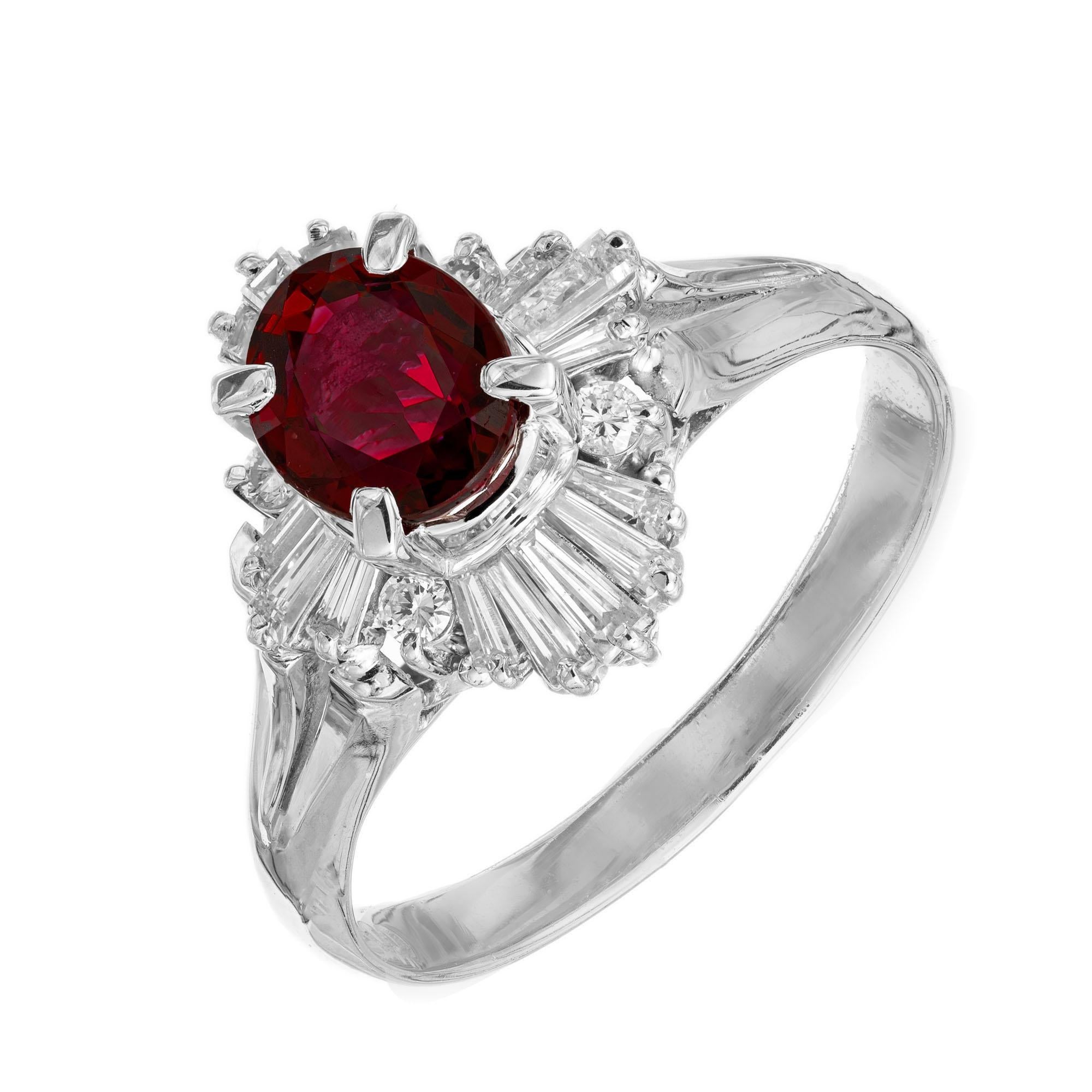 Ruby and diamond ring. GIA certified center stone with a halo of round and baguette diamonds in a handmade platinum setting. 

1 oval red ruby, SI approx. .95ct GIA Certificate # 2211312051
16 baguette diamonds, G-H SI approx. 
4 round brilliant cut