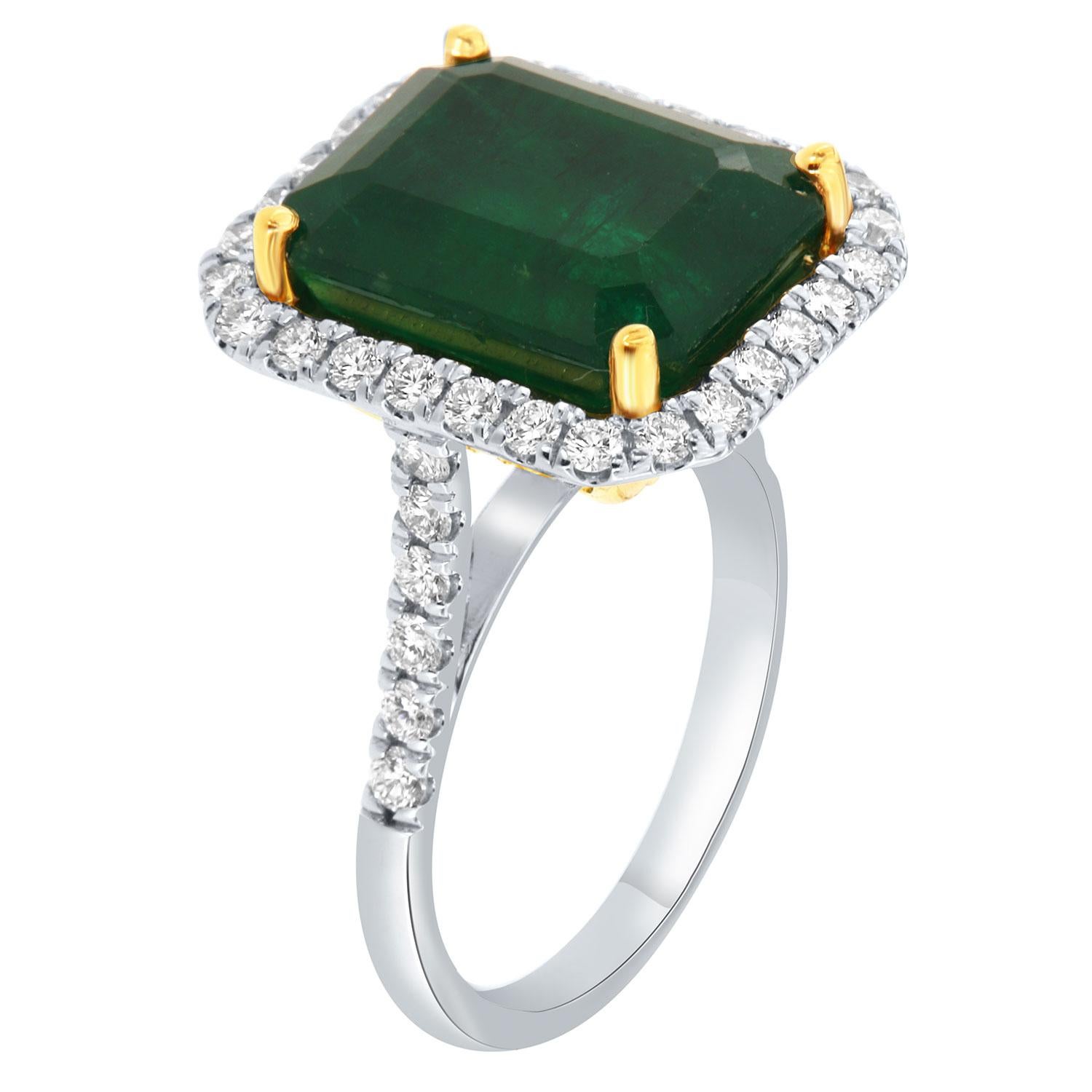 This 14K White and Yellow gold ring feature a GIA Certified 9.57-Carat Emerald cut Natural Green Emerald from Zambia. A halo of brilliant round diamonds encircles the emerald. Three rows of diamonds Micro-Prong set underneath the halo on the yellow